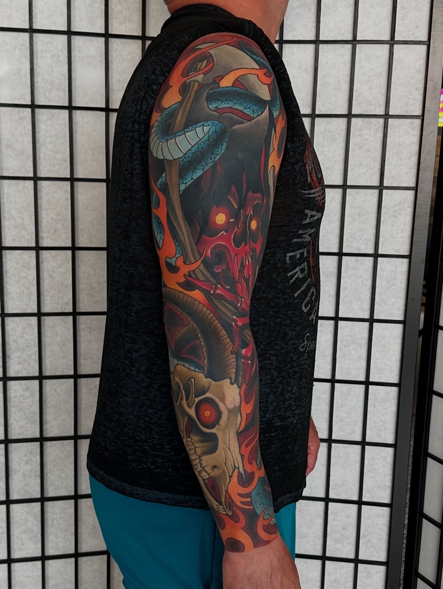 Skull and snake American traditional tattoo on the upper arm by Pat Patterson Florida Tattoo Artist