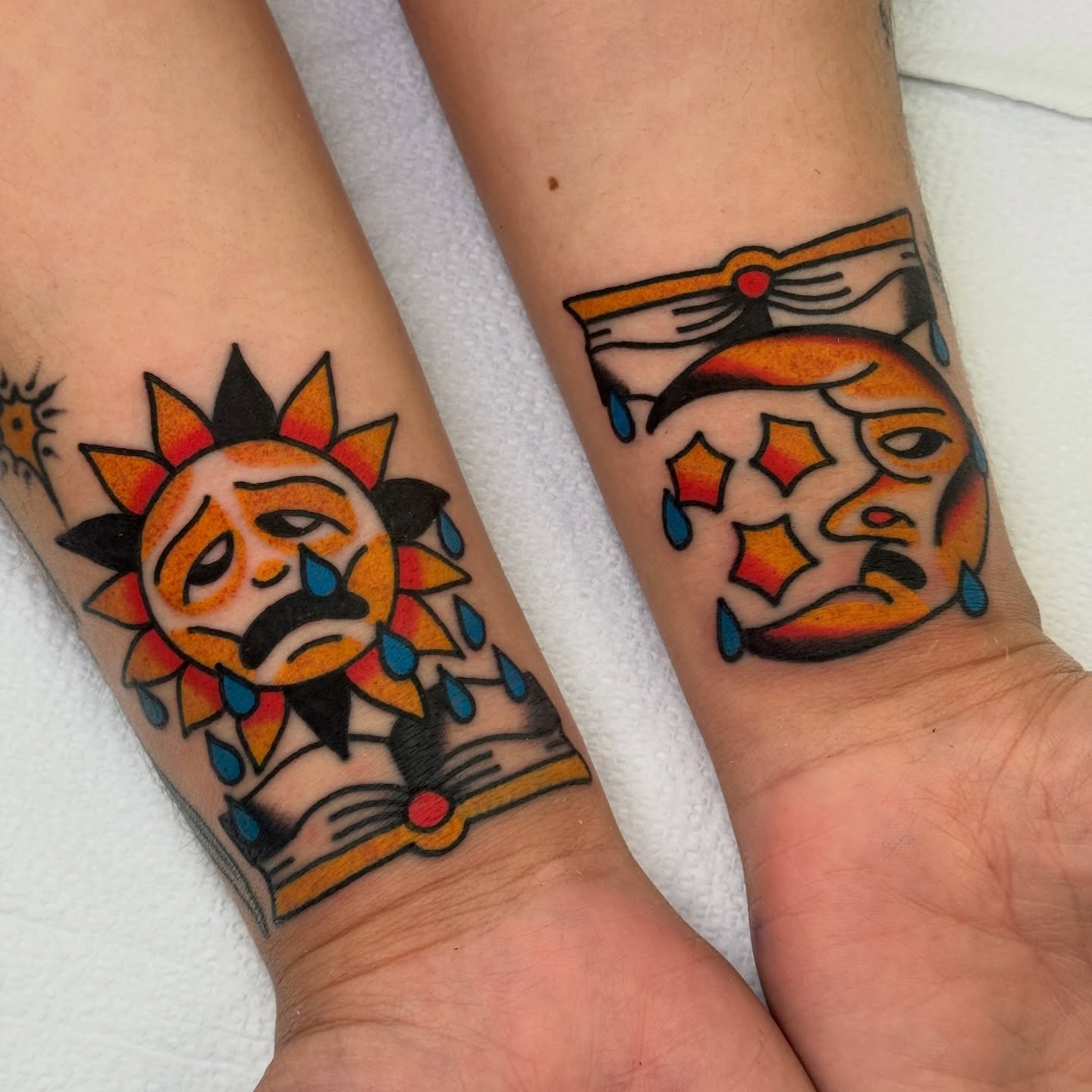 Sad sun and mask American traditional tattoo on the forearm by Rafael Torres, San Francisco, California
