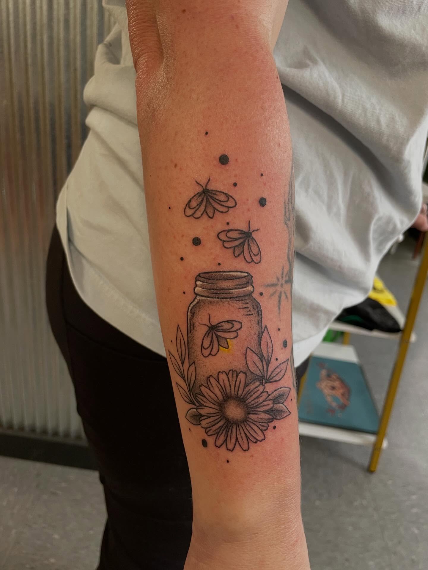 Jar with flowers and bees dotwork tattoo on the forearm by Mallory Moore