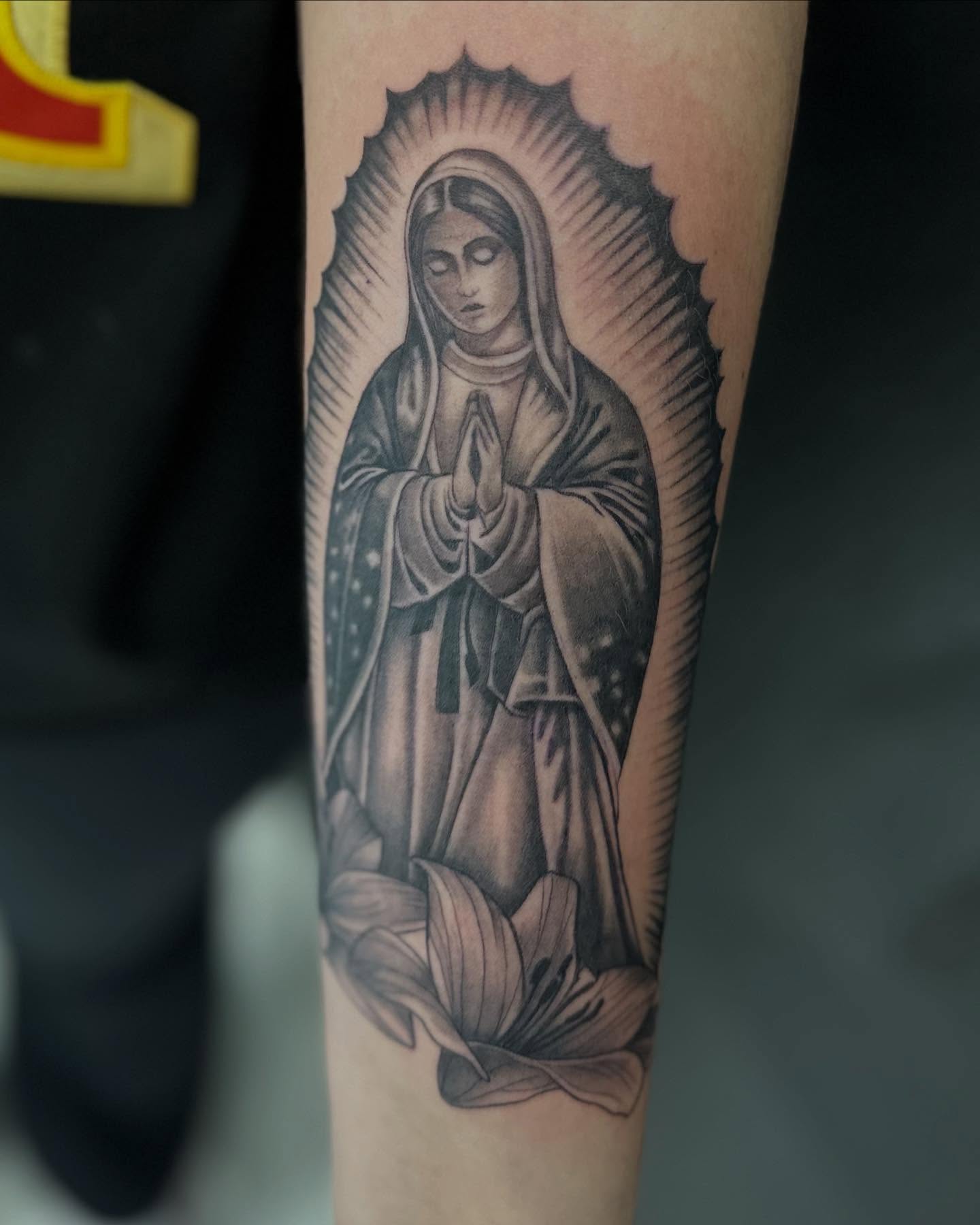 Virgin mary black and grey tattoo on the forearm by Vicious Marc