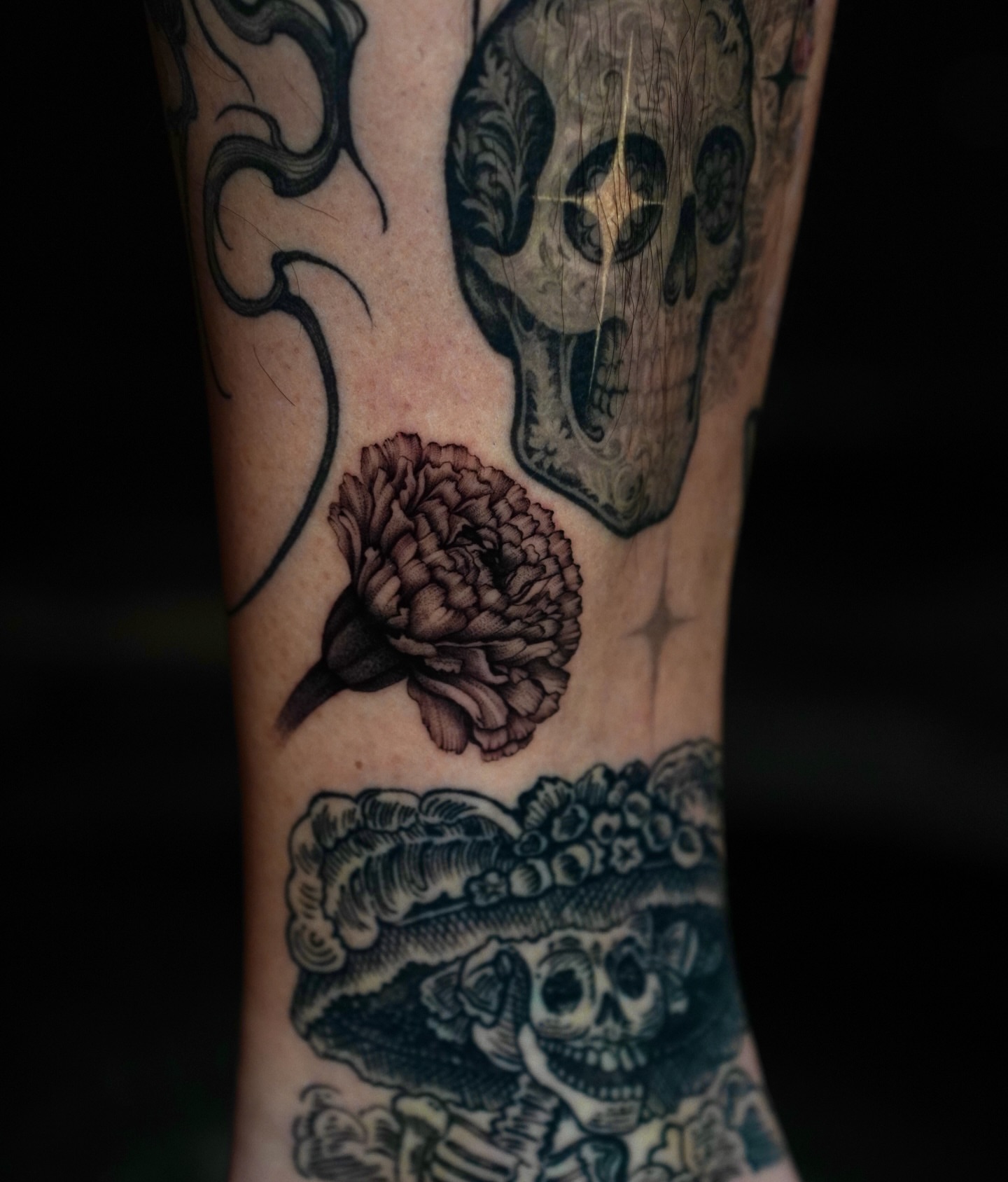 Skulls and marigold American traditional tattoo on the forearm by Sophia Delfino