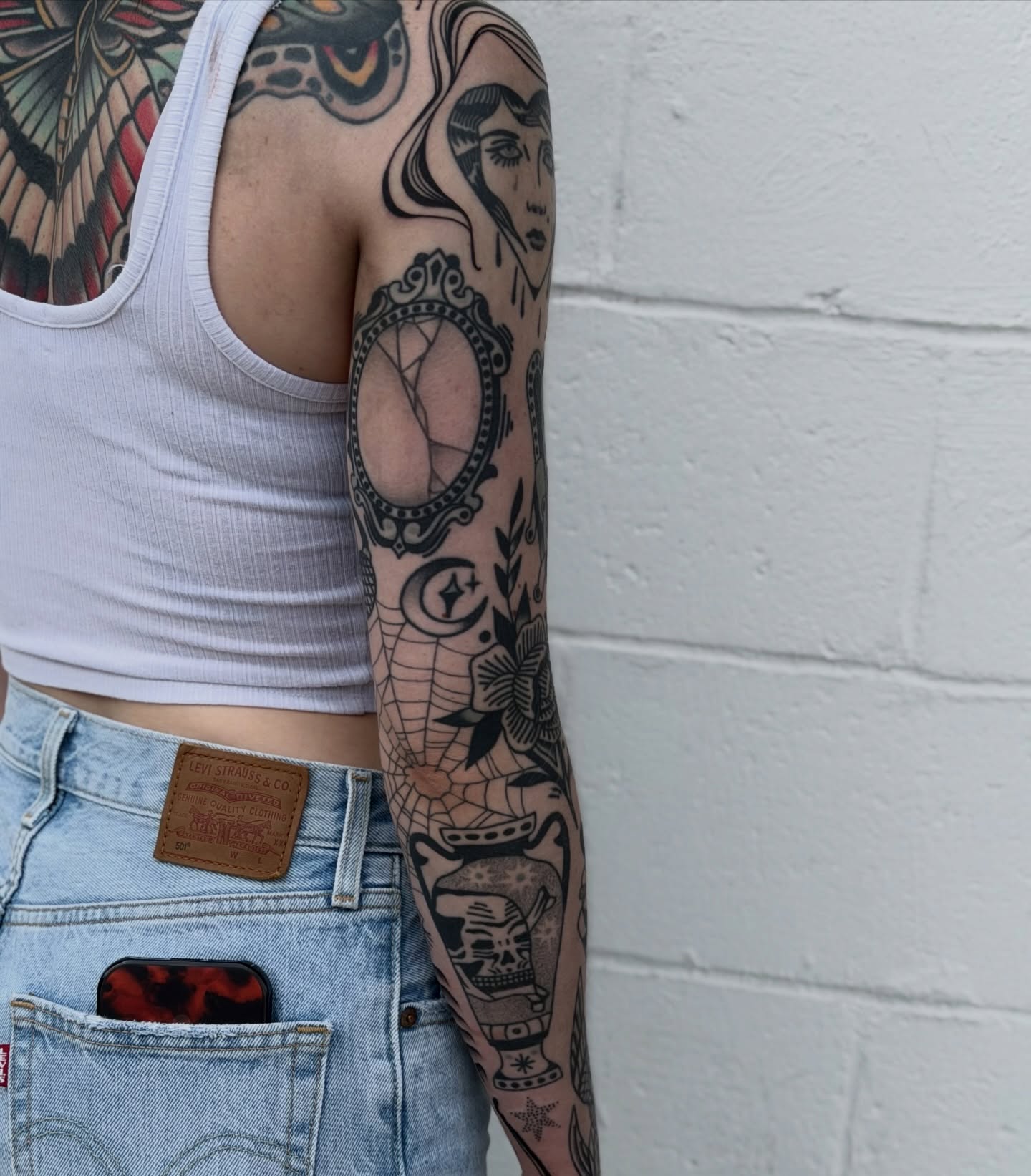 Woman's face American traditional tattoo on the upper arm by Maks