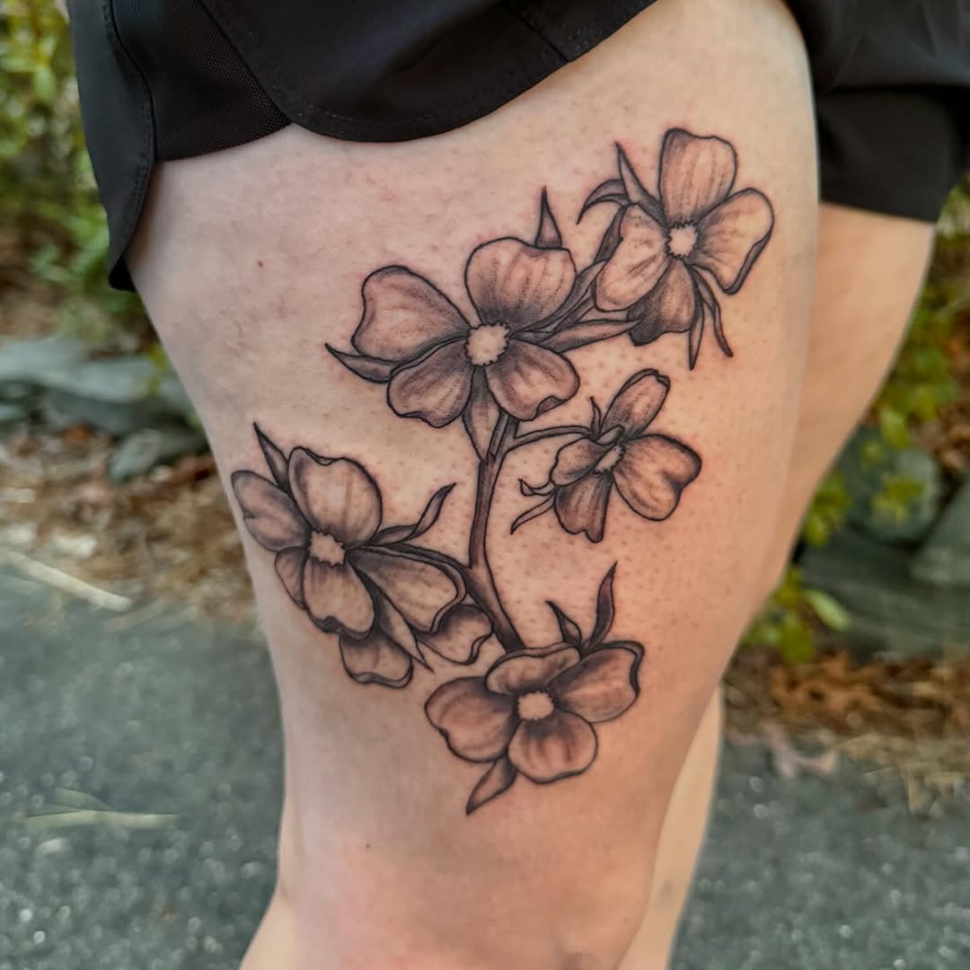 Dogwood flowers fine line tattoo on the thigh by K. Bel Art