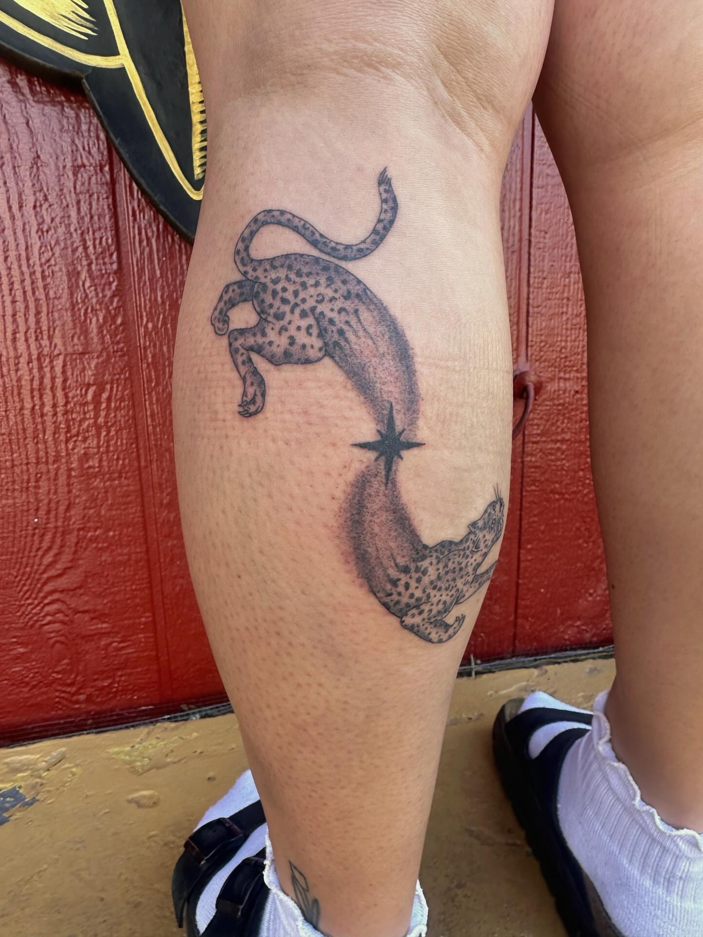 Leopard and star black and grey tattoo on the forearm by J Valentin