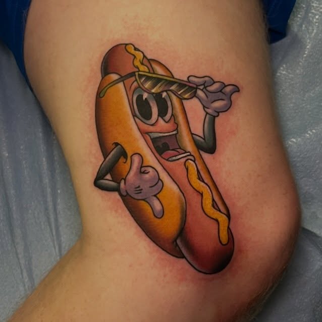 Hot dog realism tattoo on the thigh by Evan Perrine