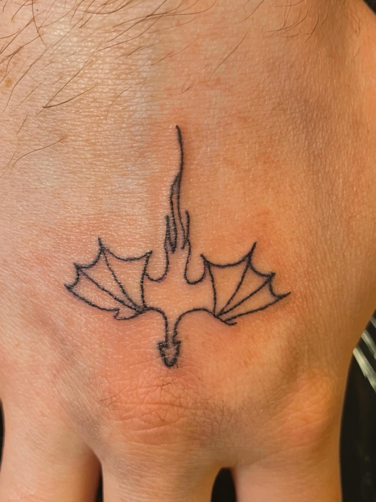 Bat minimalist tattoo on the chest by 𝚃𝙰𝚃𝚃𝙾𝙾 𝙰𝚁𝚃𝙸𝚂𝚃, Charlotte, North Carolina