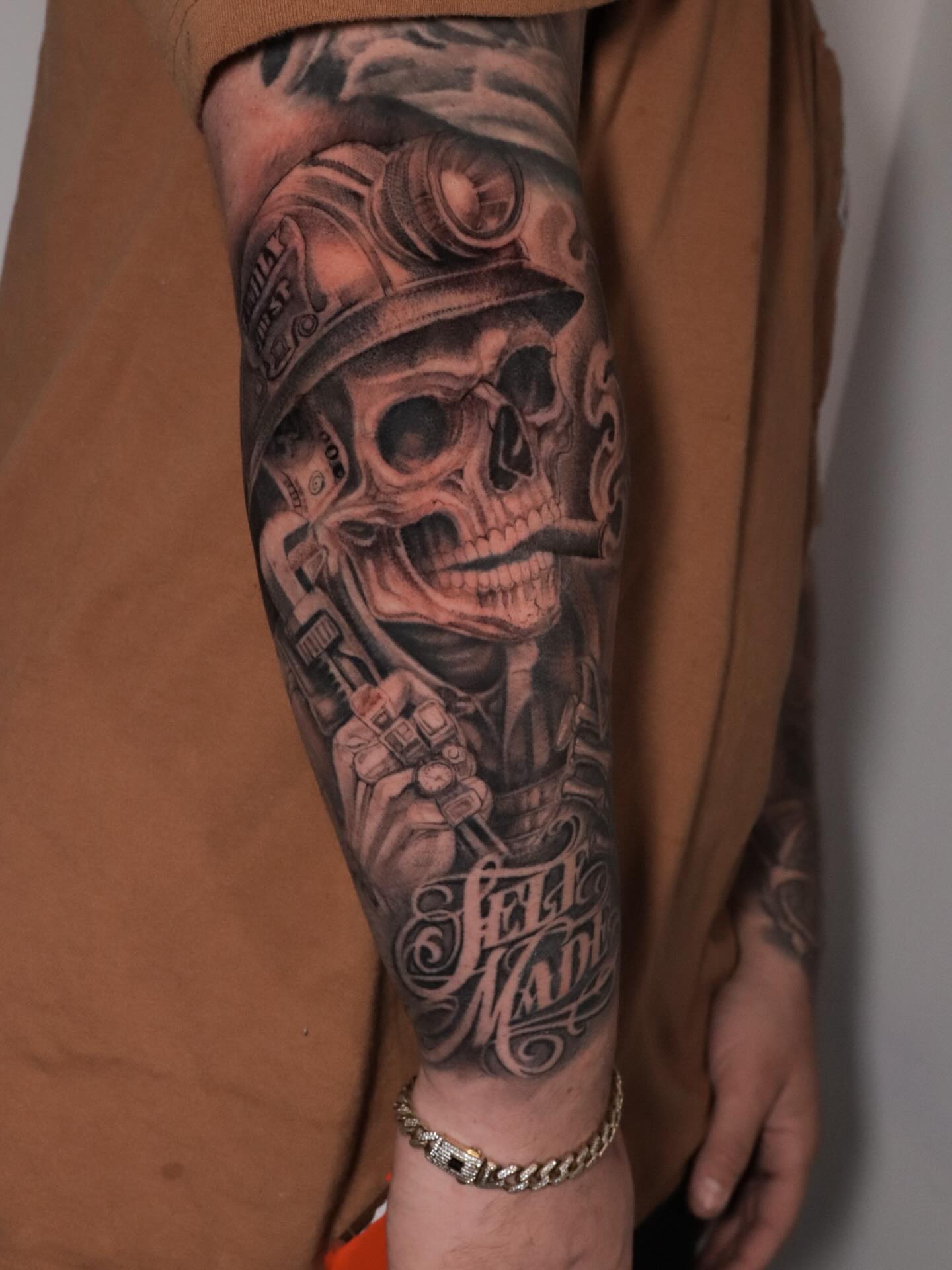 Miner skull realism tattoo on the forearm by elvis flores