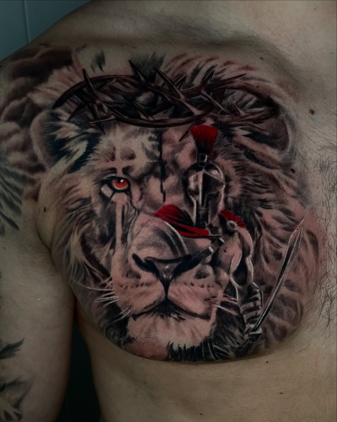 Lion and spartan warrior realism tattoo on the chest by Tattoo Artist