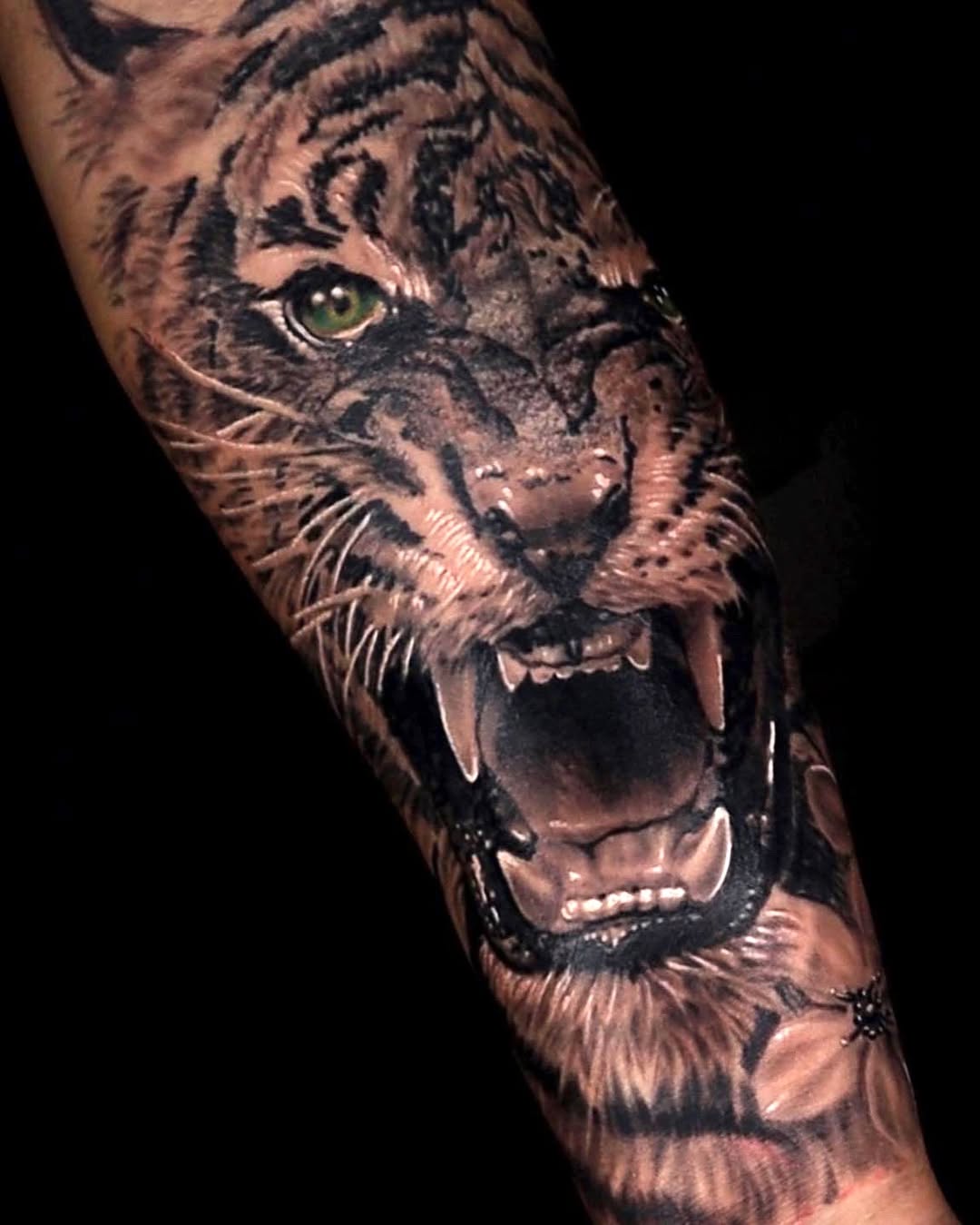 Tiger face realism tattoo on the forearm by Tattoo Artist