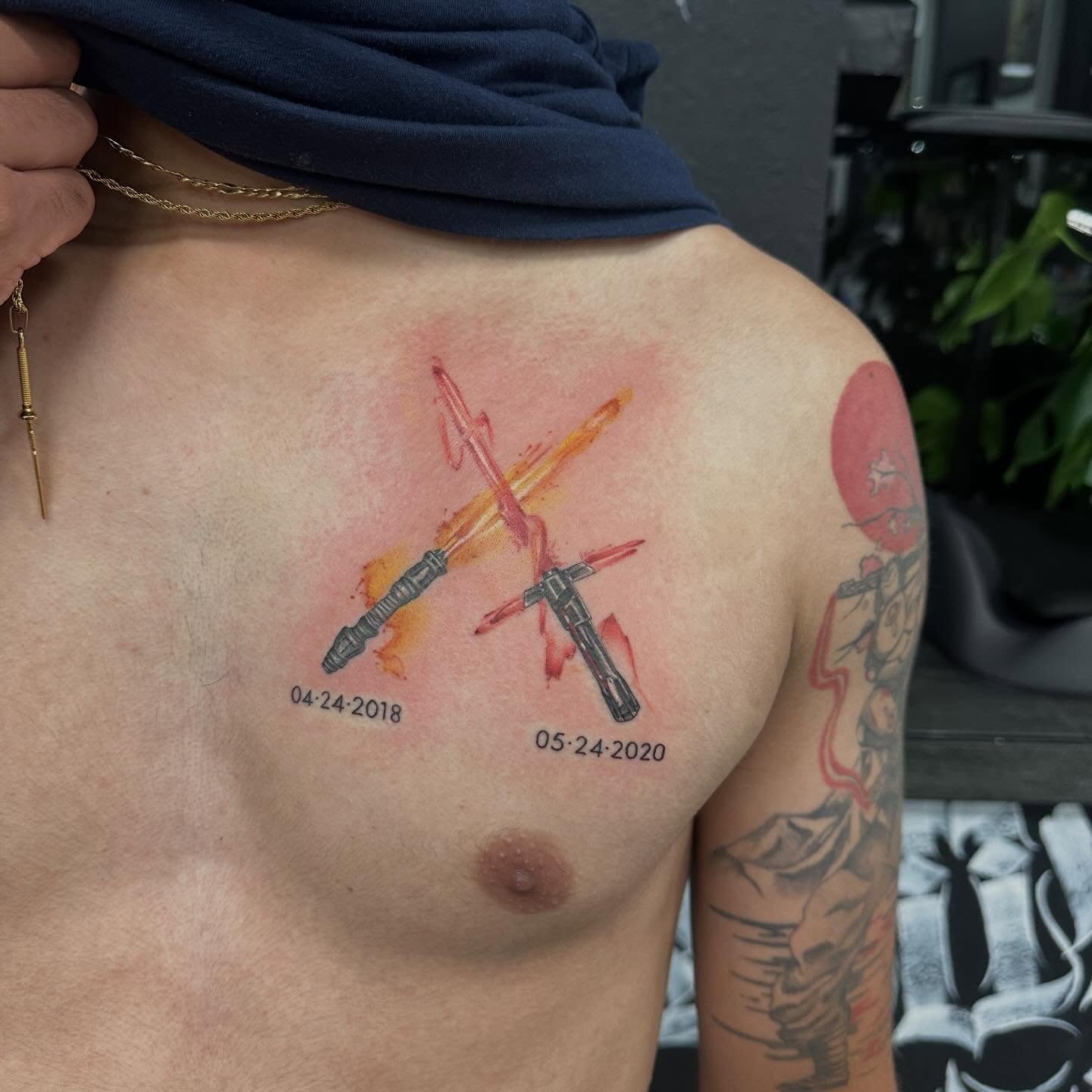 Lightsaber duel watercolor tattoo on the chest by Katrina Aldaco 🧿 Tattoo Artist