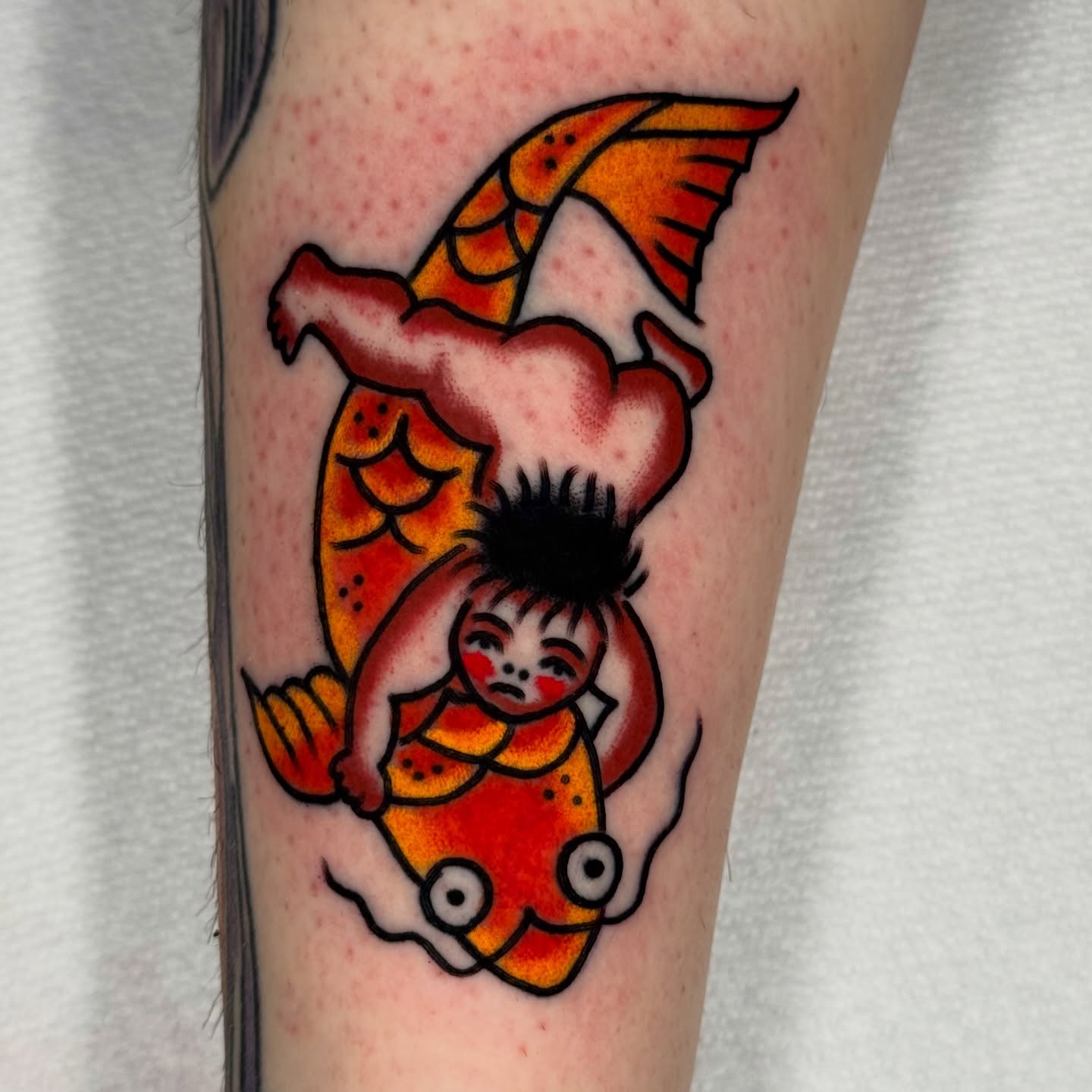 Koi fish and child American traditional tattoo on the forearm by Joe Bear Tattooer