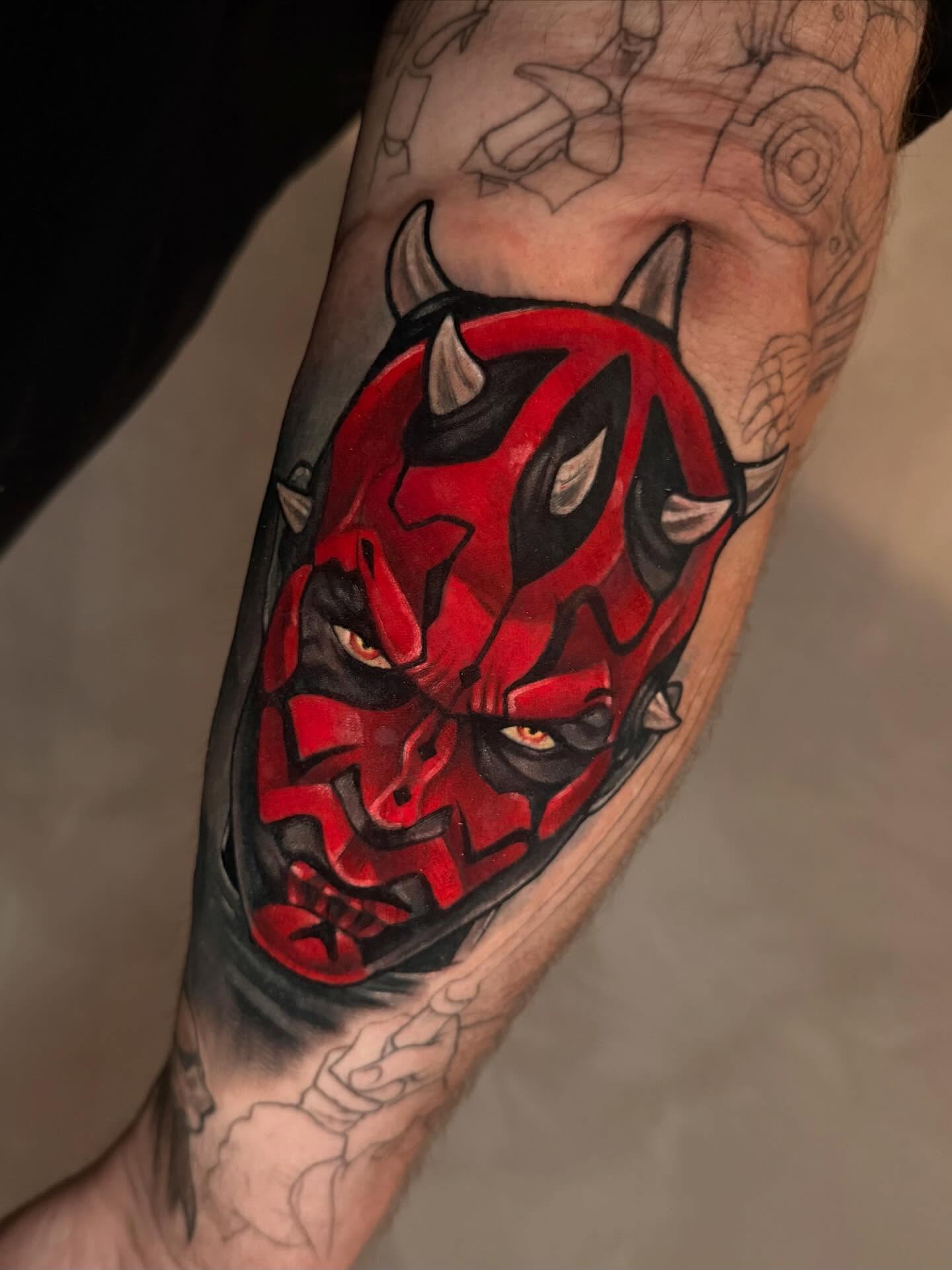 Demon mask geometric tattoo on the forearm by emi