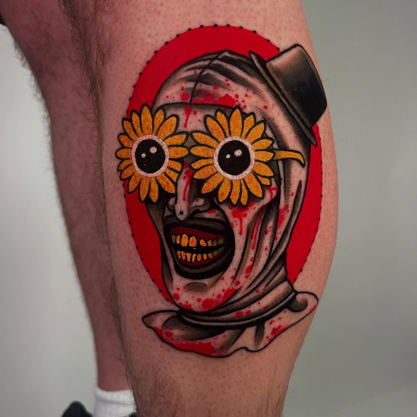 Clown with sunflowers American traditional tattoo on the forearm by Sara Lewis