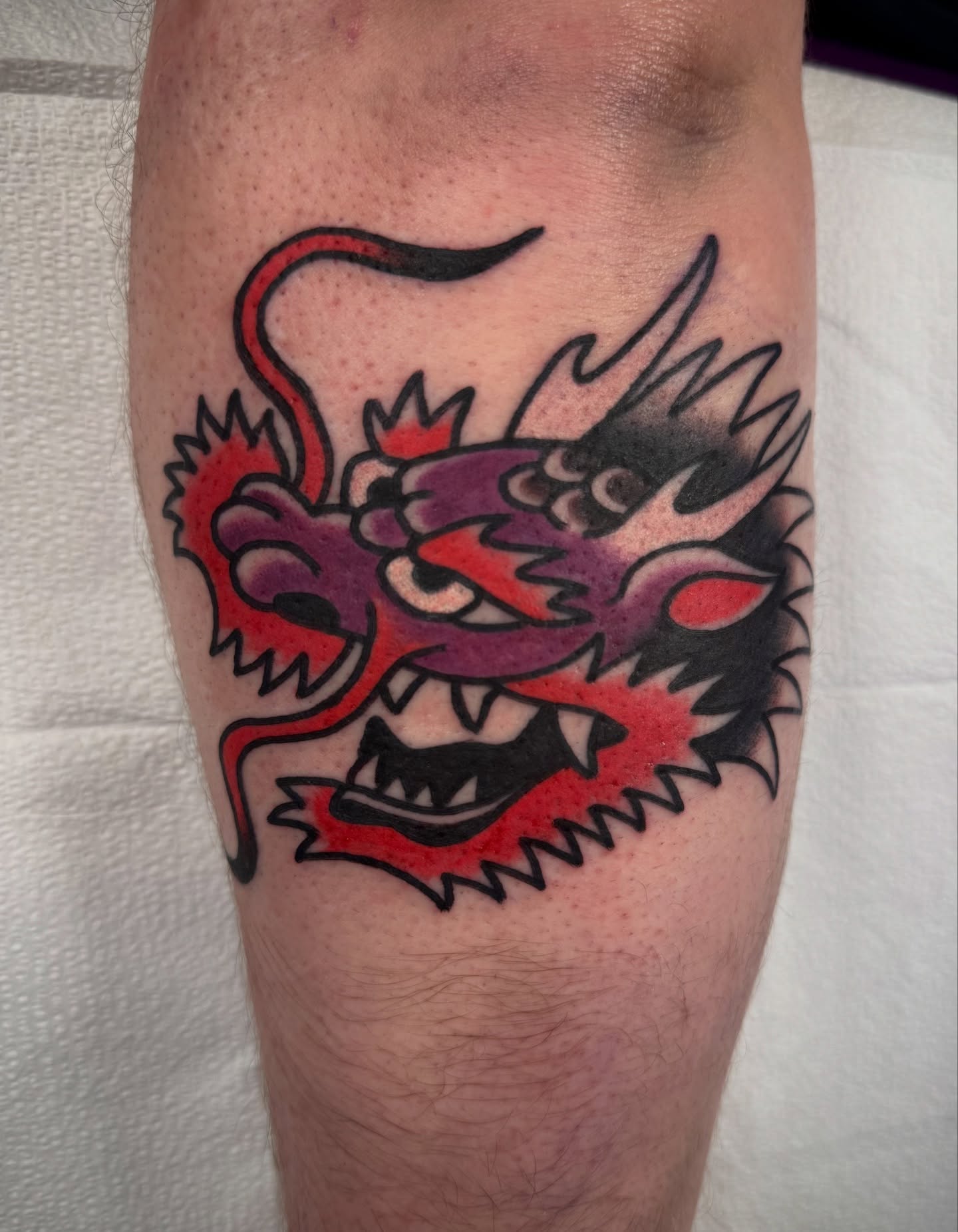 Dragon head American traditional tattoo on the forearm by mike