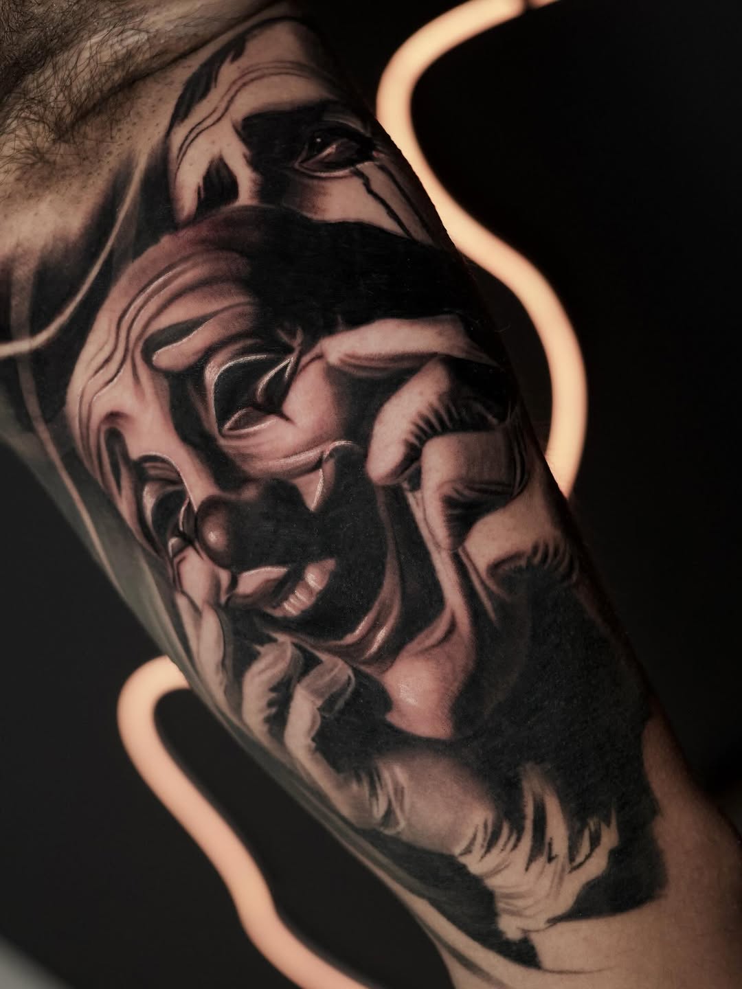 Clown face realism tattoo on the forearm by Bapone