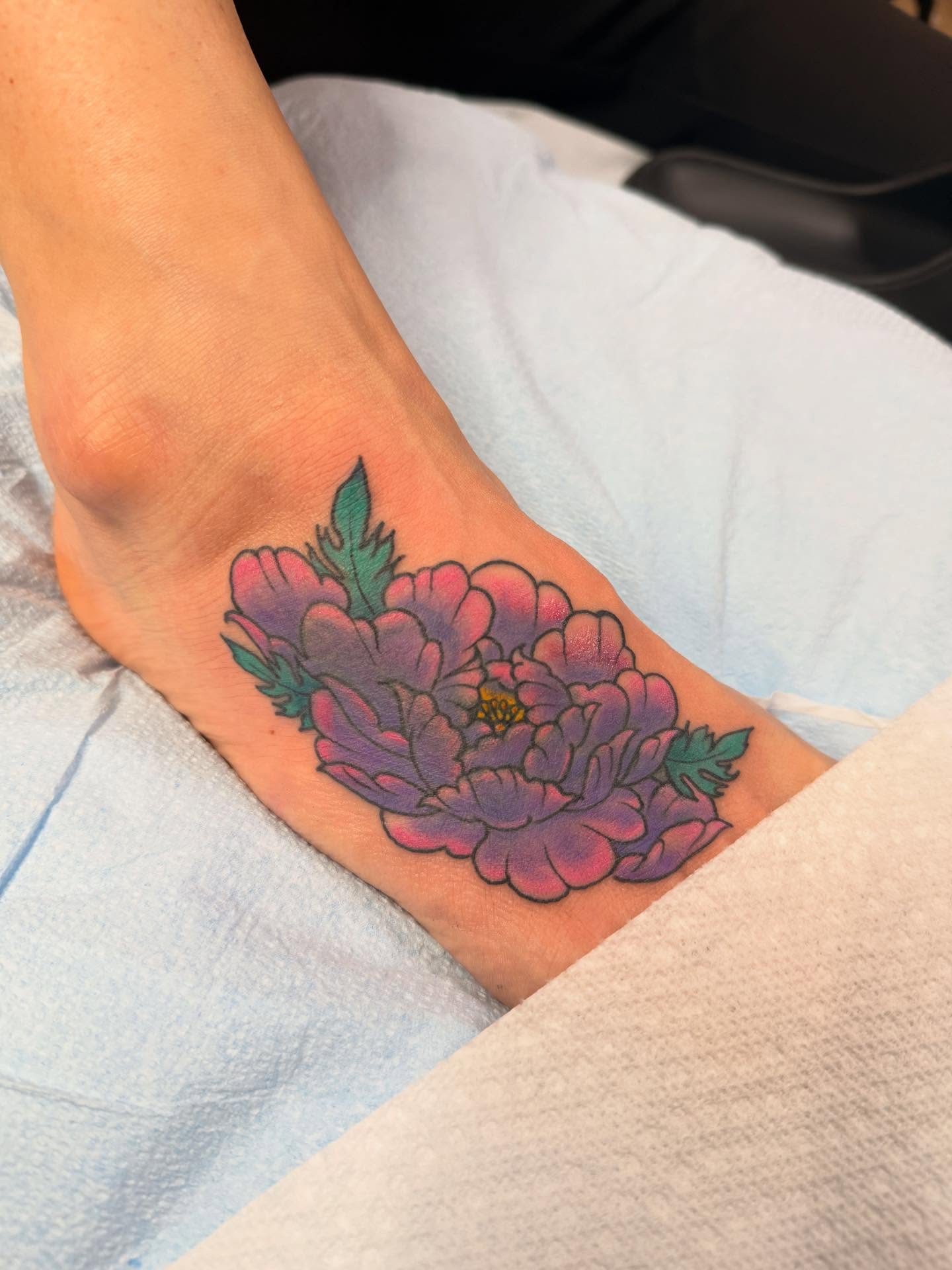 Flower new school tattoo on the foot by Megan Sue Causemaker