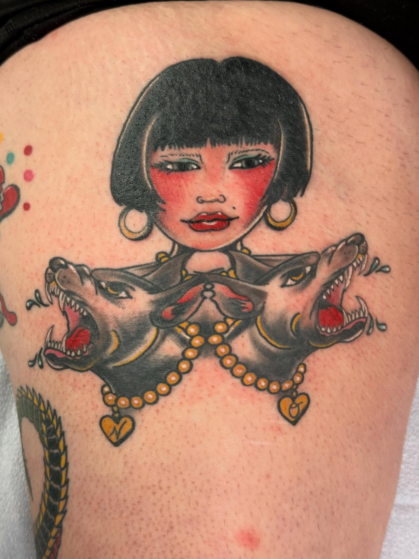 Woman with wolves American traditional tattoo on the thigh by Megan Sue Causemaker