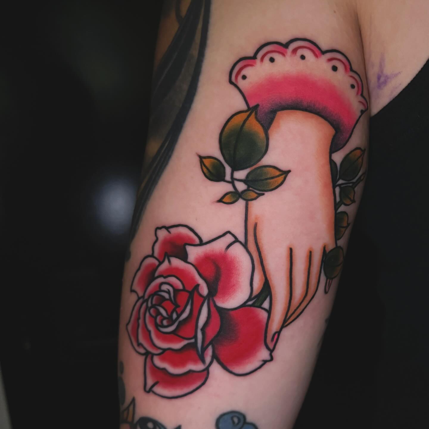 Rose and hand American traditional tattoo on the forearm by Nikki Bee