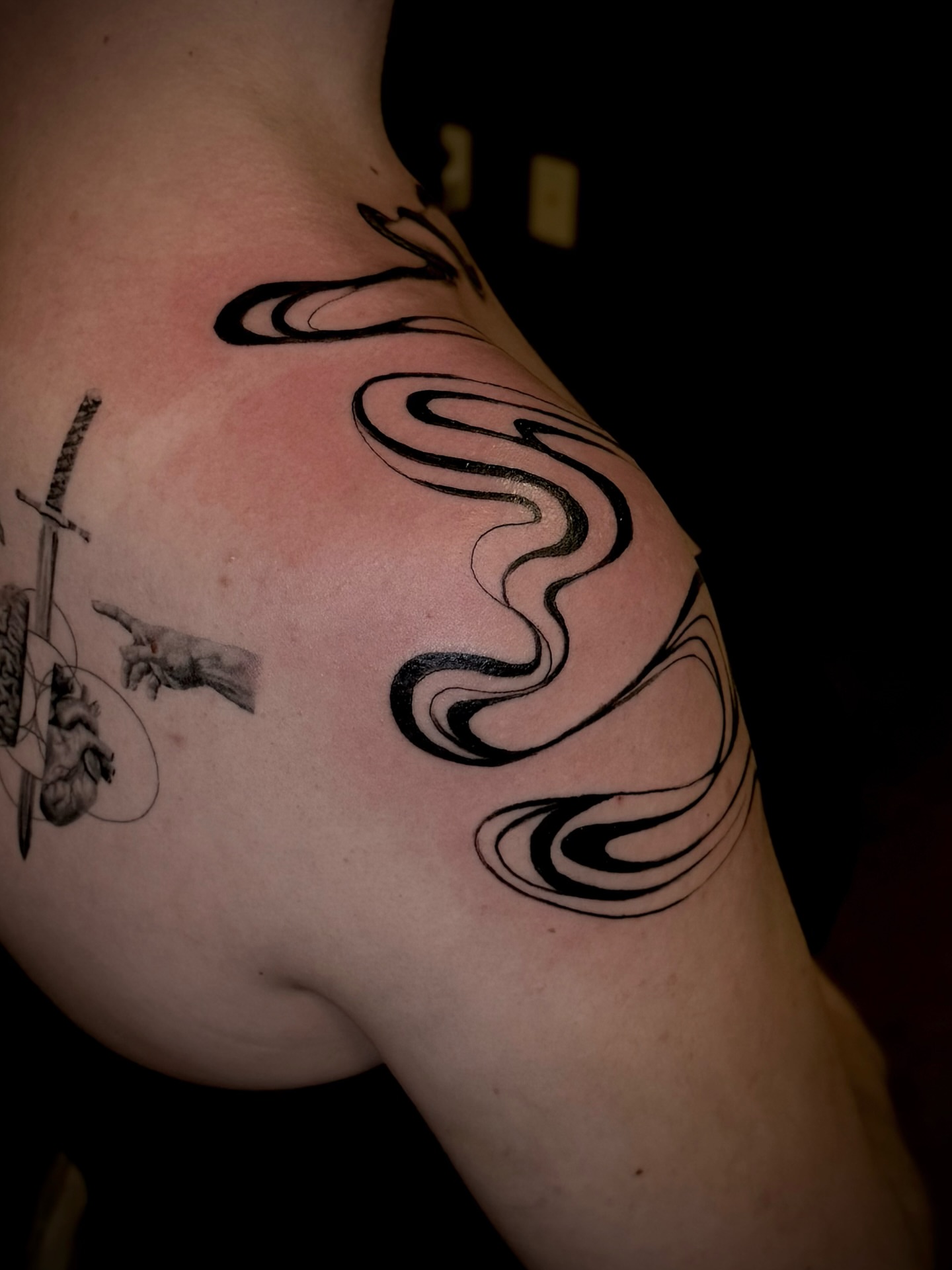 Abstract swirls black and grey tattoo on the shoulder by Thomas Martinez