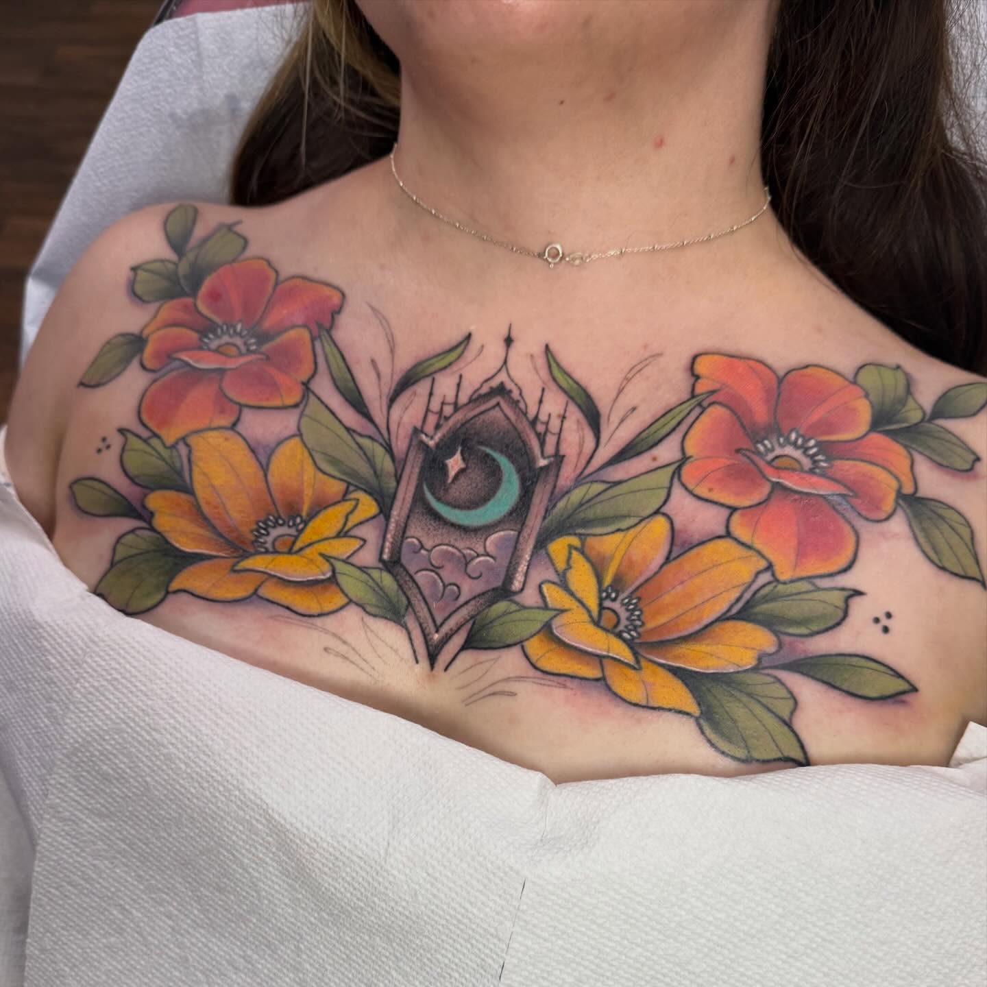 Flowers and crescent moon new school tattoo on the chest by Dameetra Davis