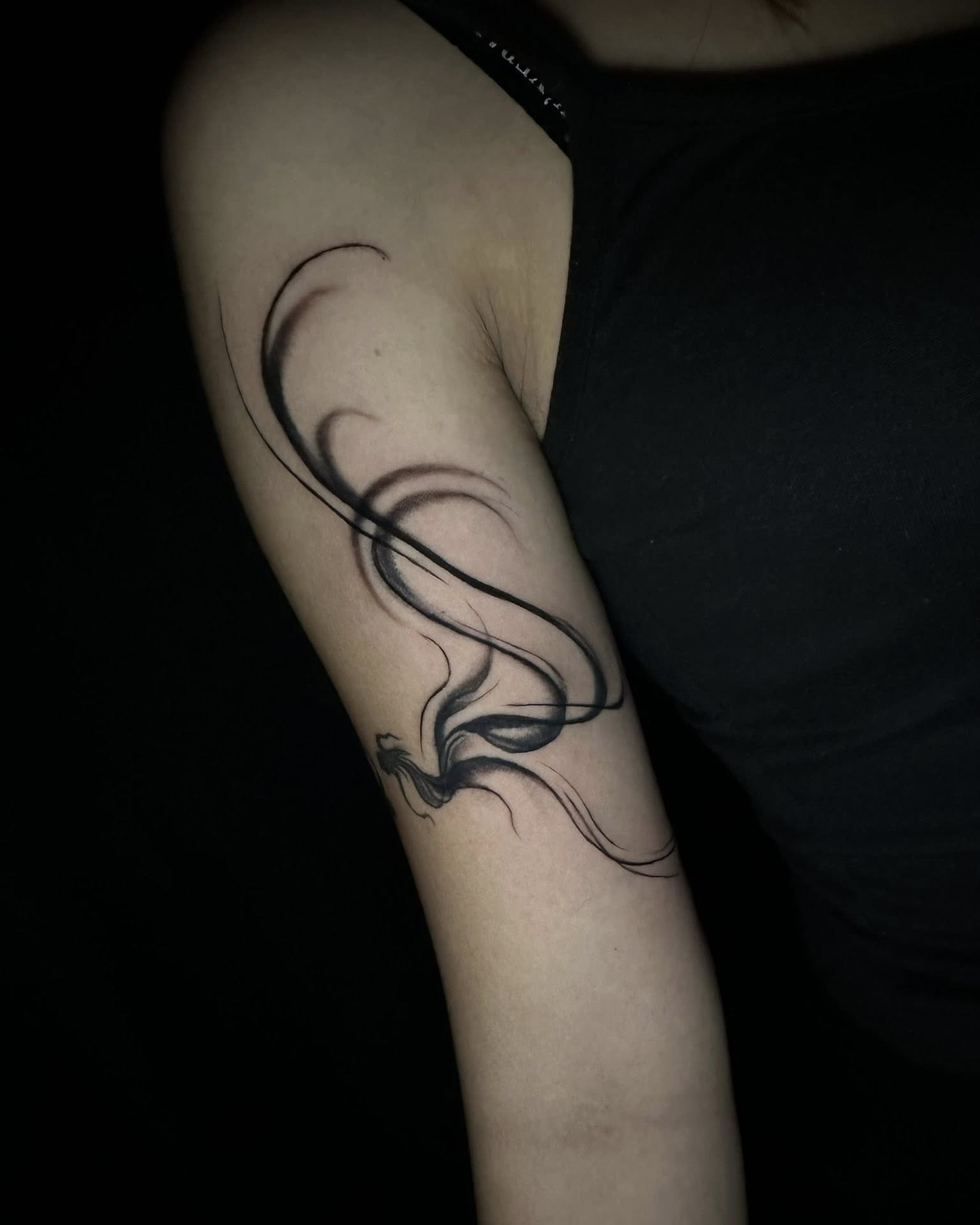 Smoke black and grey tattoo on the forearm by Stephen Degracia