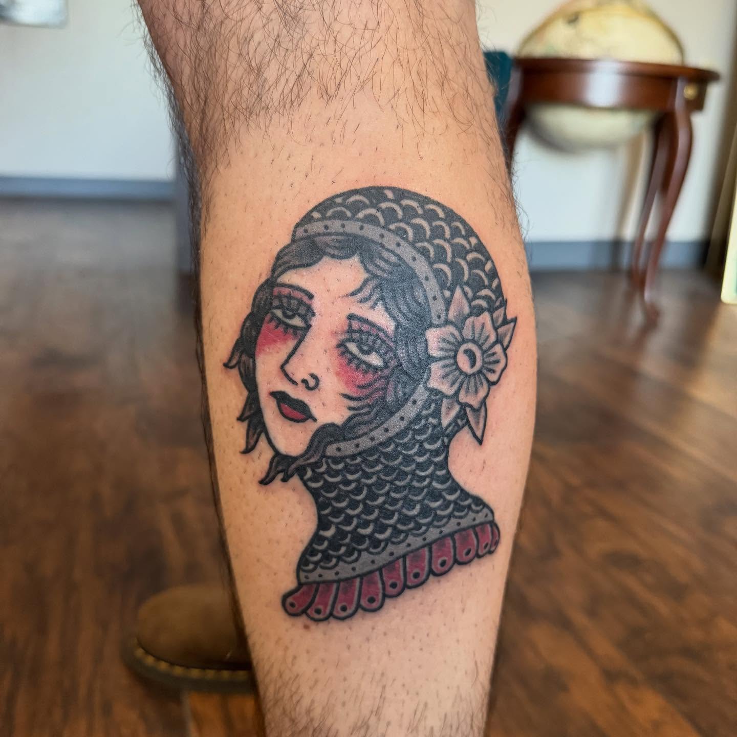 Woman with fish scale armor American traditional tattoo on the forearm by Joe Truck