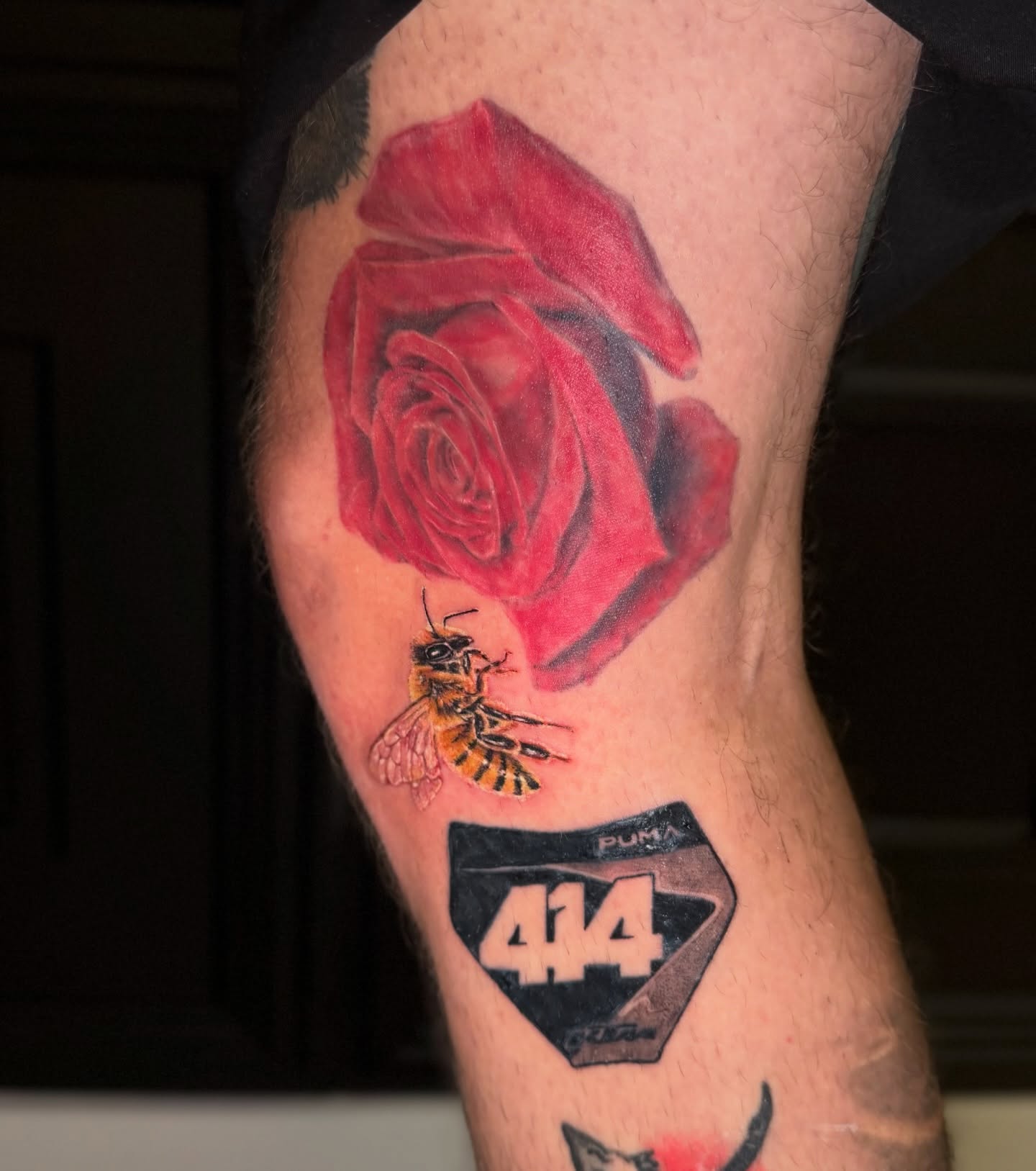 Red rose with bee realism tattoo on the forearm by πππ¦