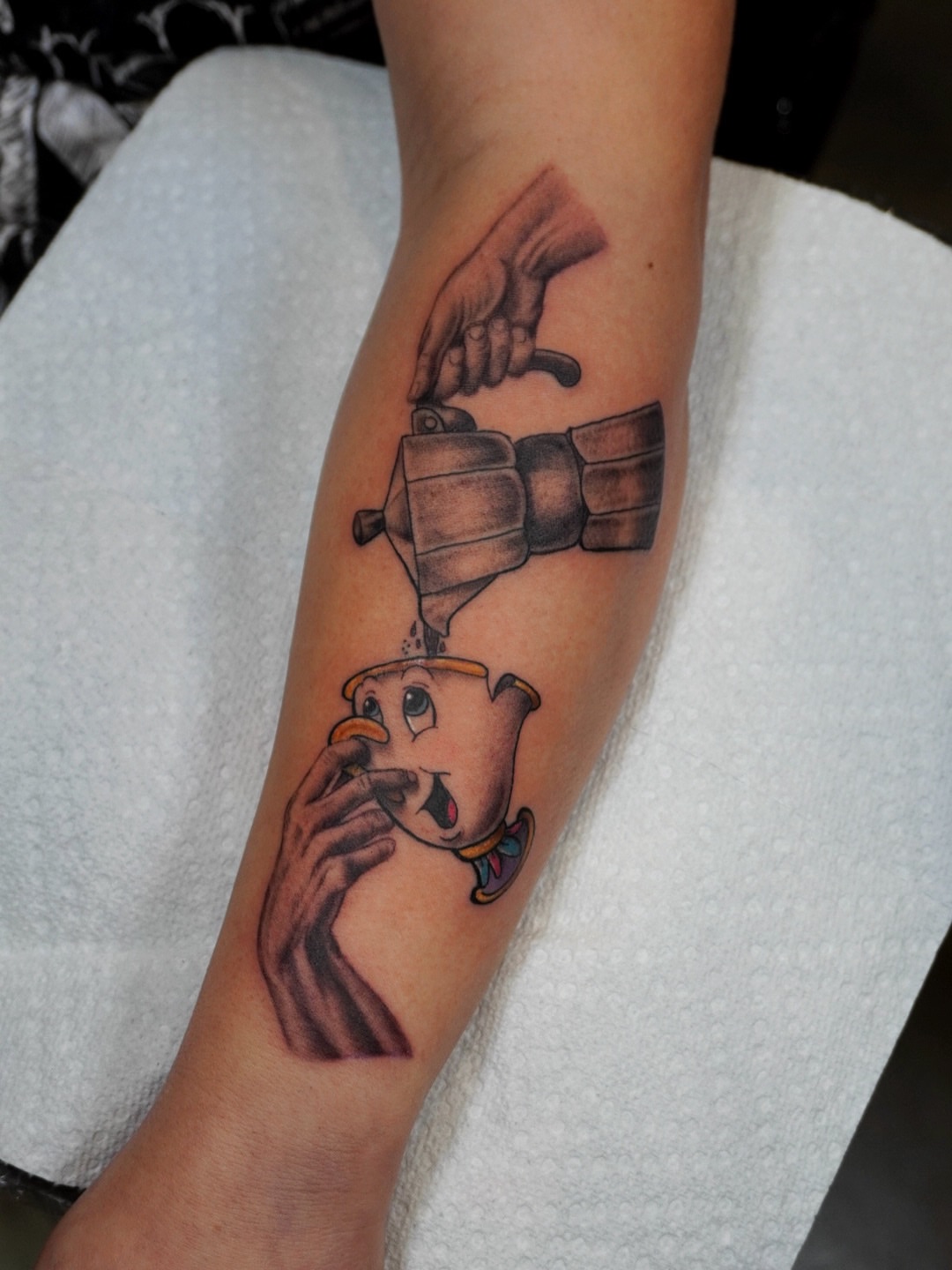 Coffee pot pouring into teacup realism tattoo on the forearm by Ericka Hampton, Ferndale, Michigan
