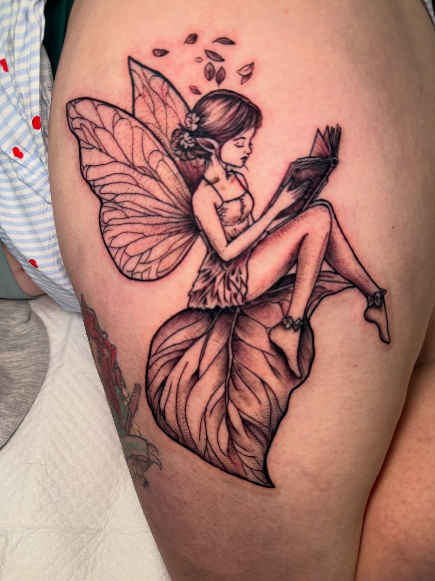 Fairy reading dotwork tattoo on the thigh by Butta