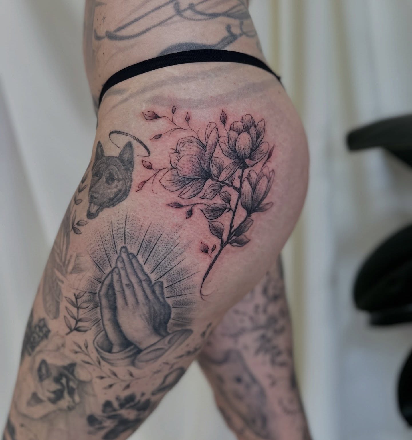 Praying hands and flowers dotwork tattoo on the thigh by Ric Castellon Tattoo Artist, Los Angeles, California