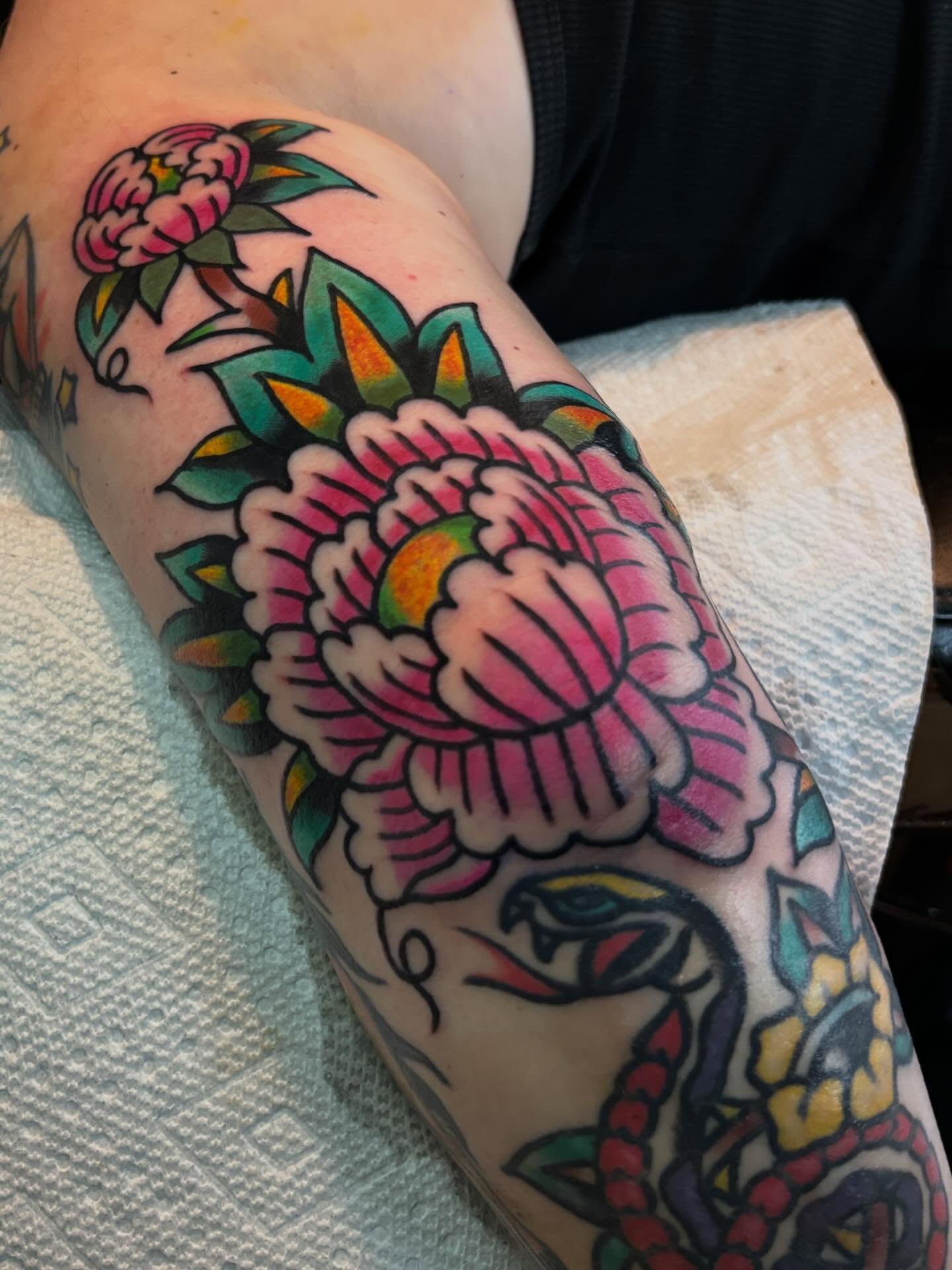 Peony American traditional tattoo on the forearm by Mitch Ashpaugh