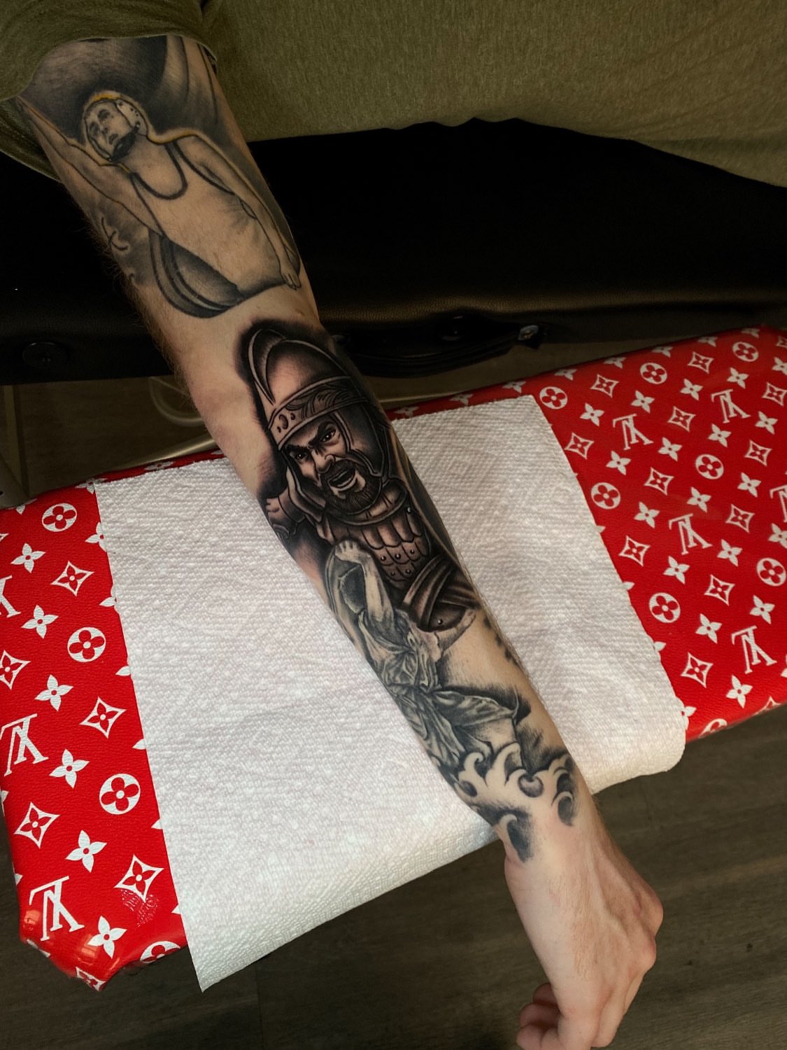 Warrior and crucifixion realism tattoo on the forearm by Kelan Mckenna