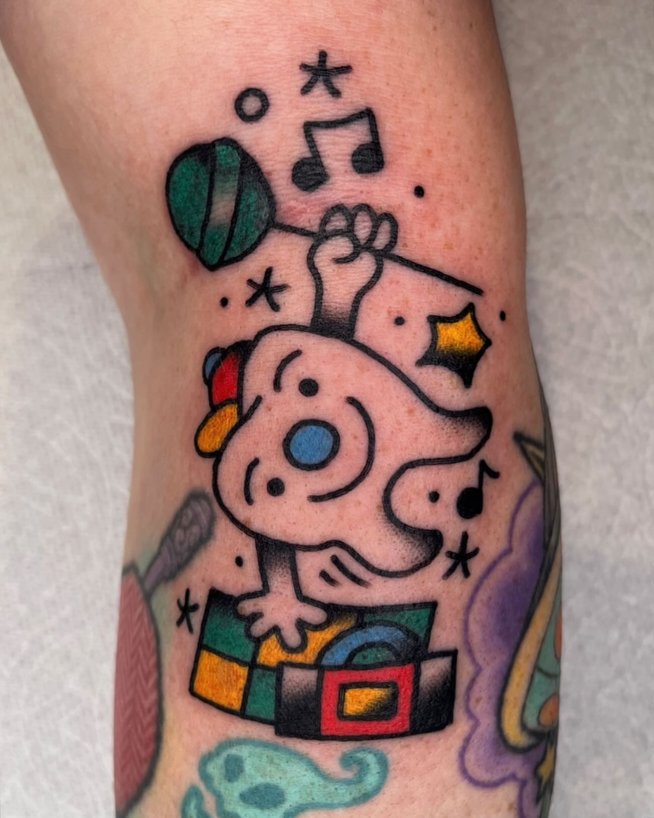 Dog playing music dotwork tattoo on the forearm by Robyn Fricke