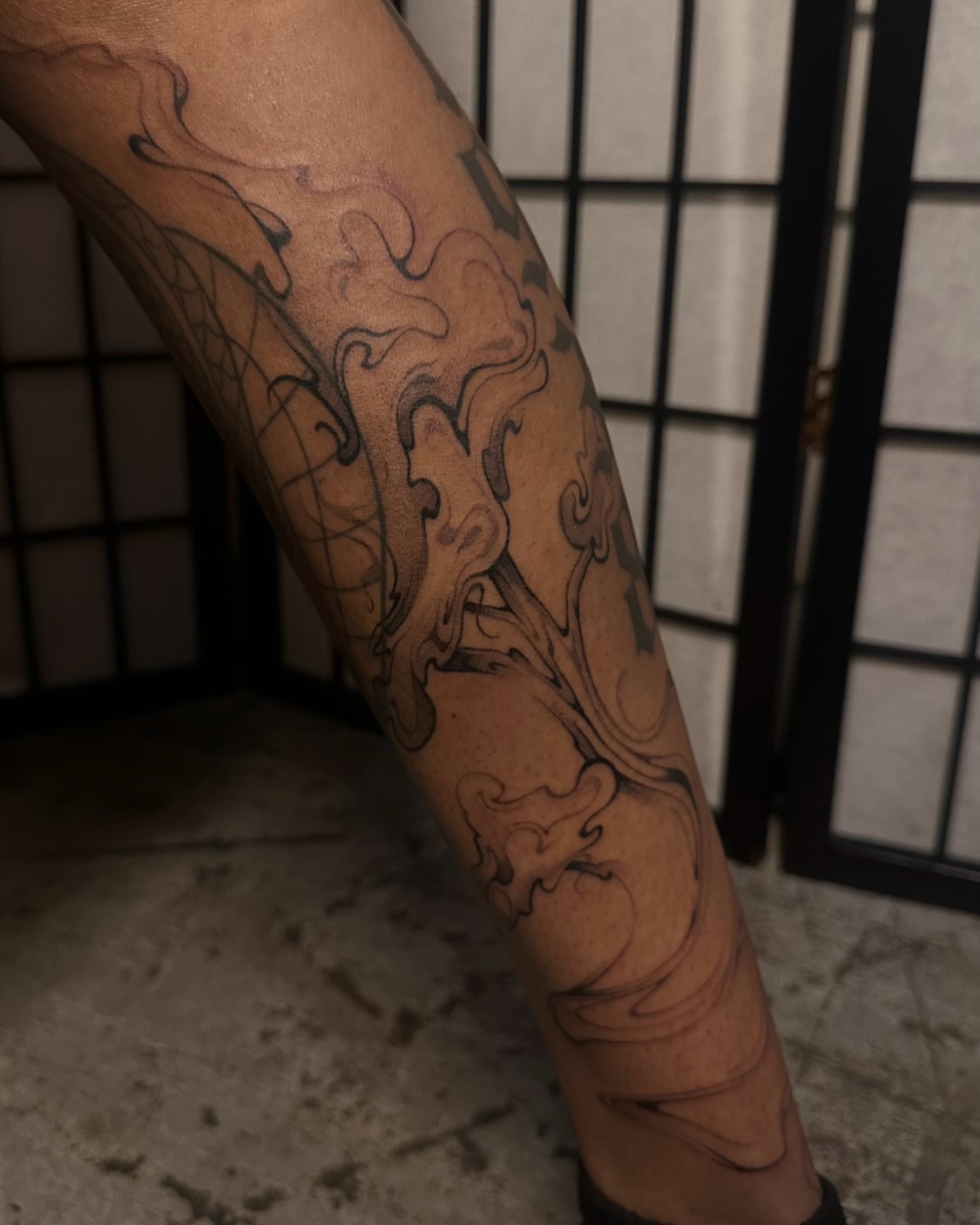 Floral design black and grey tattoo on the forearm by jun