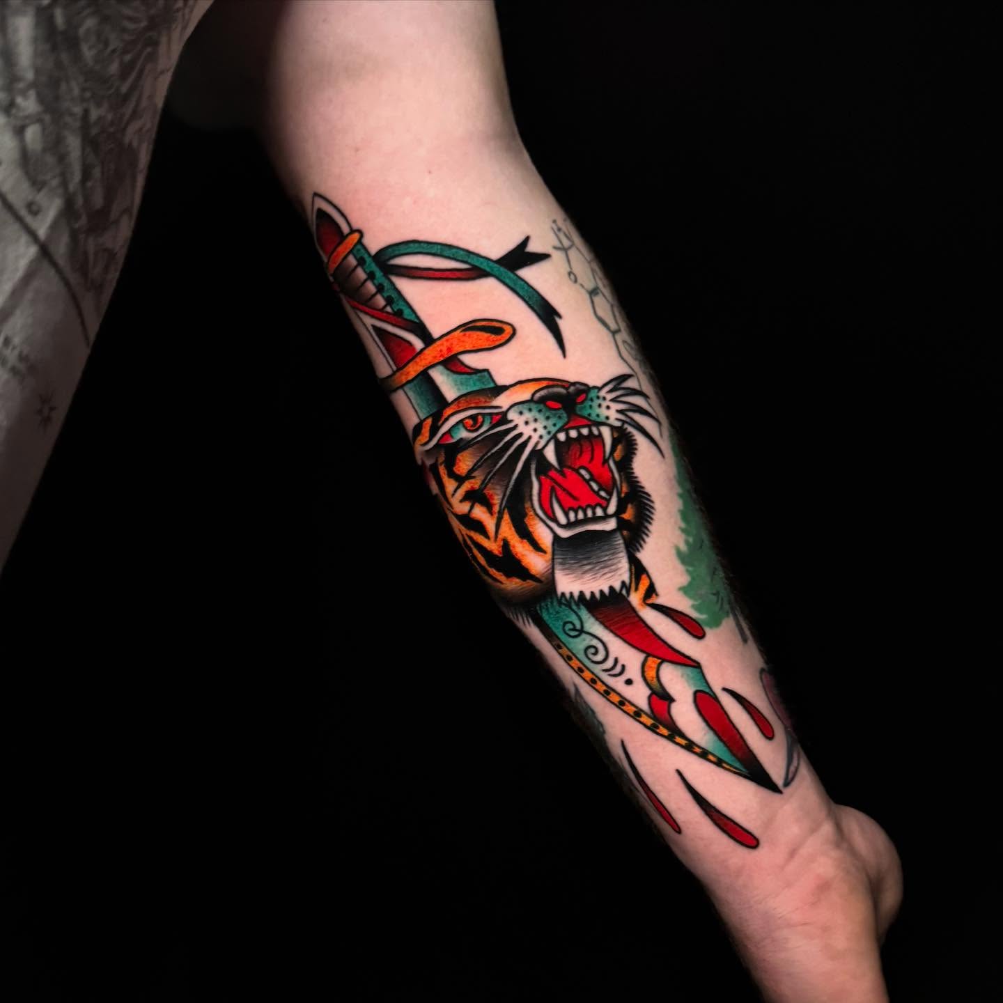 Roaring tiger American traditional tattoo on the forearm by Nate Masi