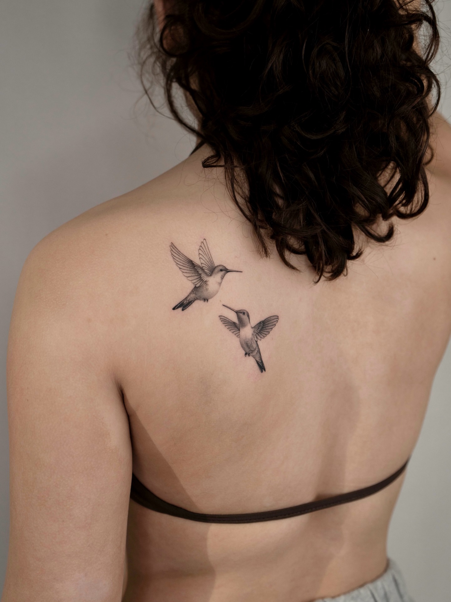 Hummingbirds black and grey tattoo on the back by t y, t a t t o o a r t i s t