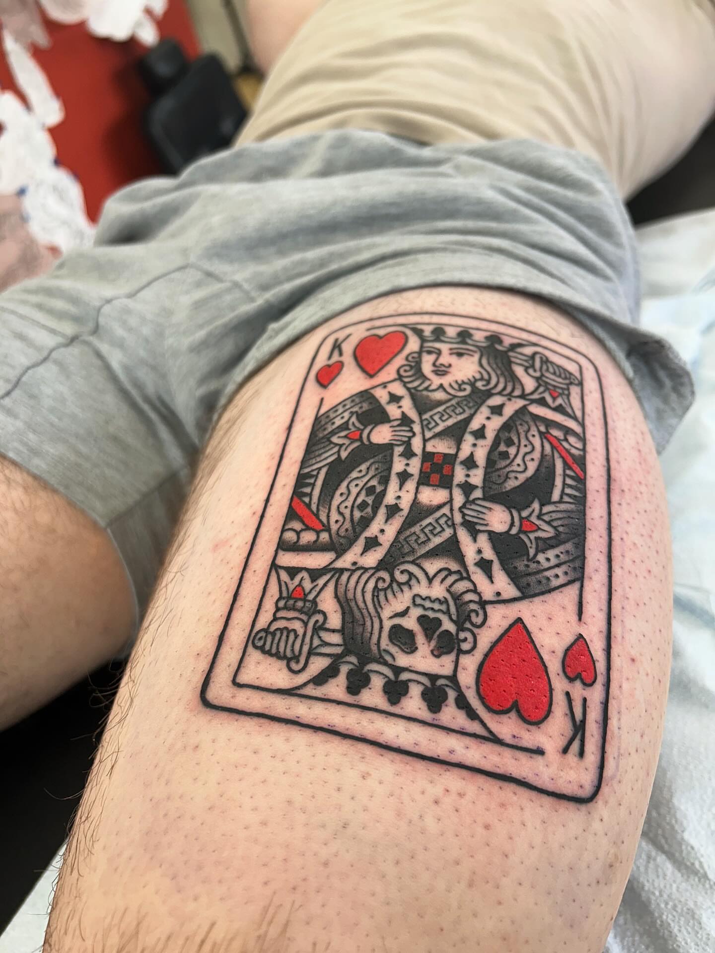 King of hearts black and grey tattoo on the thigh by Matthew Crimson