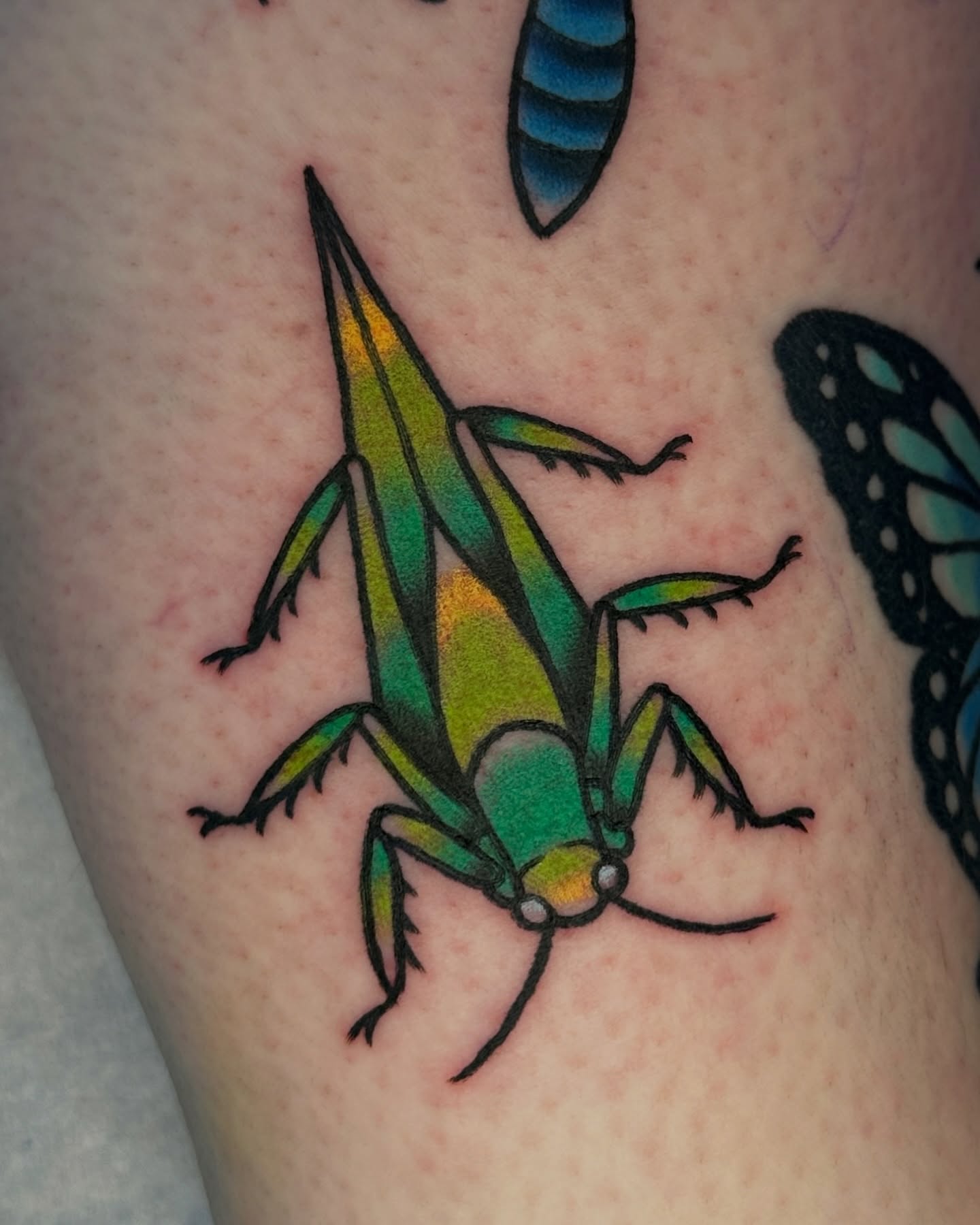 Grasshopper new school tattoo on the thigh by Paige Ochoa