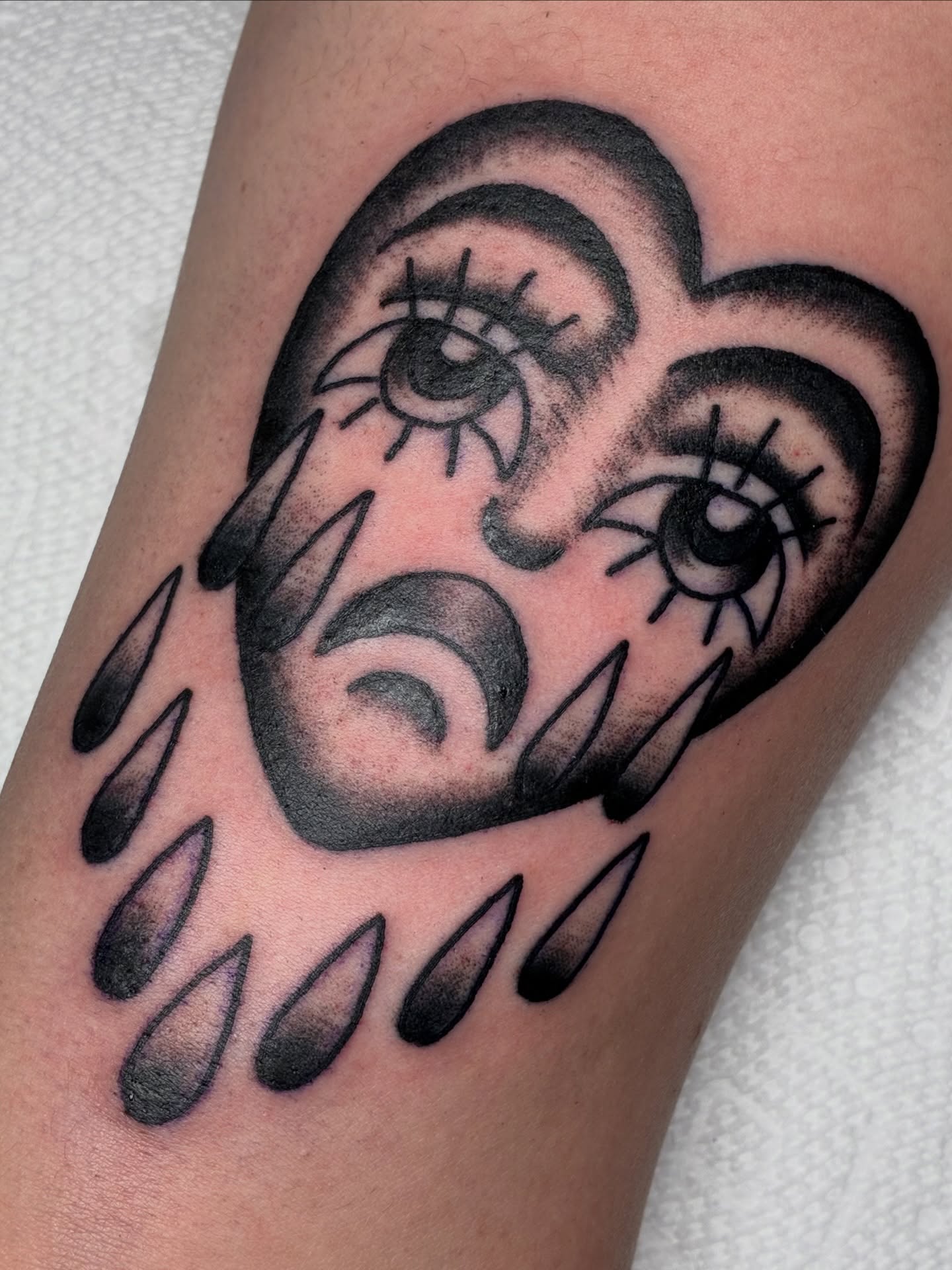 Tearful cloud black and grey tattoo on the forearm by Sav Robinson