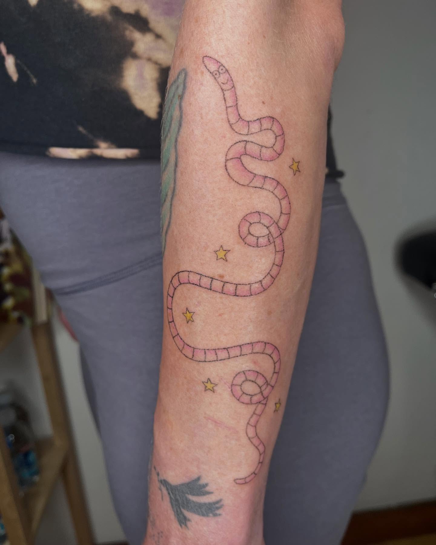 Worm and stars dotwork tattoo on the forearm by Jenna