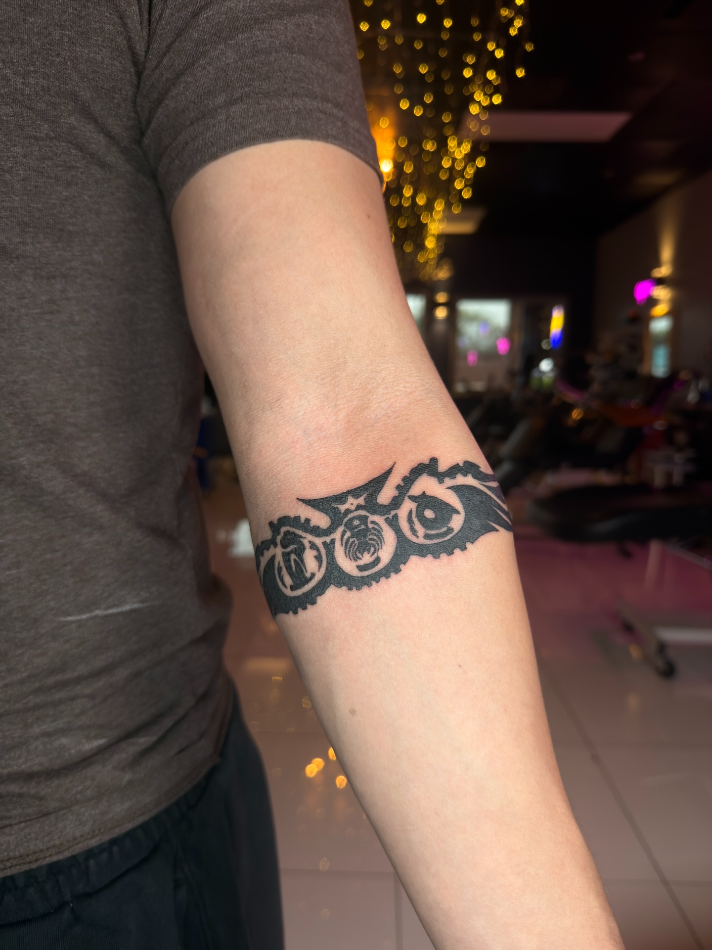 Eyes and symbols black and grey tattoo on the forearm by Vu Nguyen