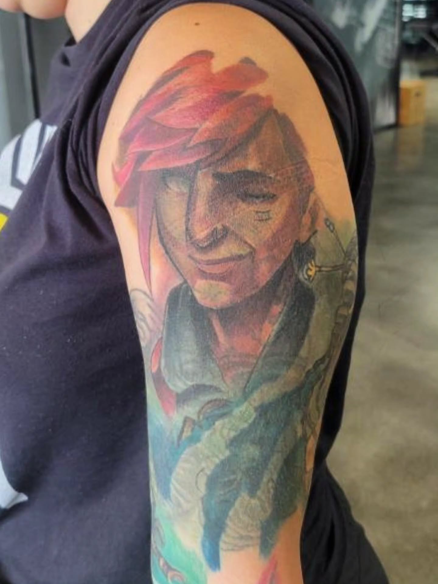 Portrait realism tattoo on the upper arm by Bo