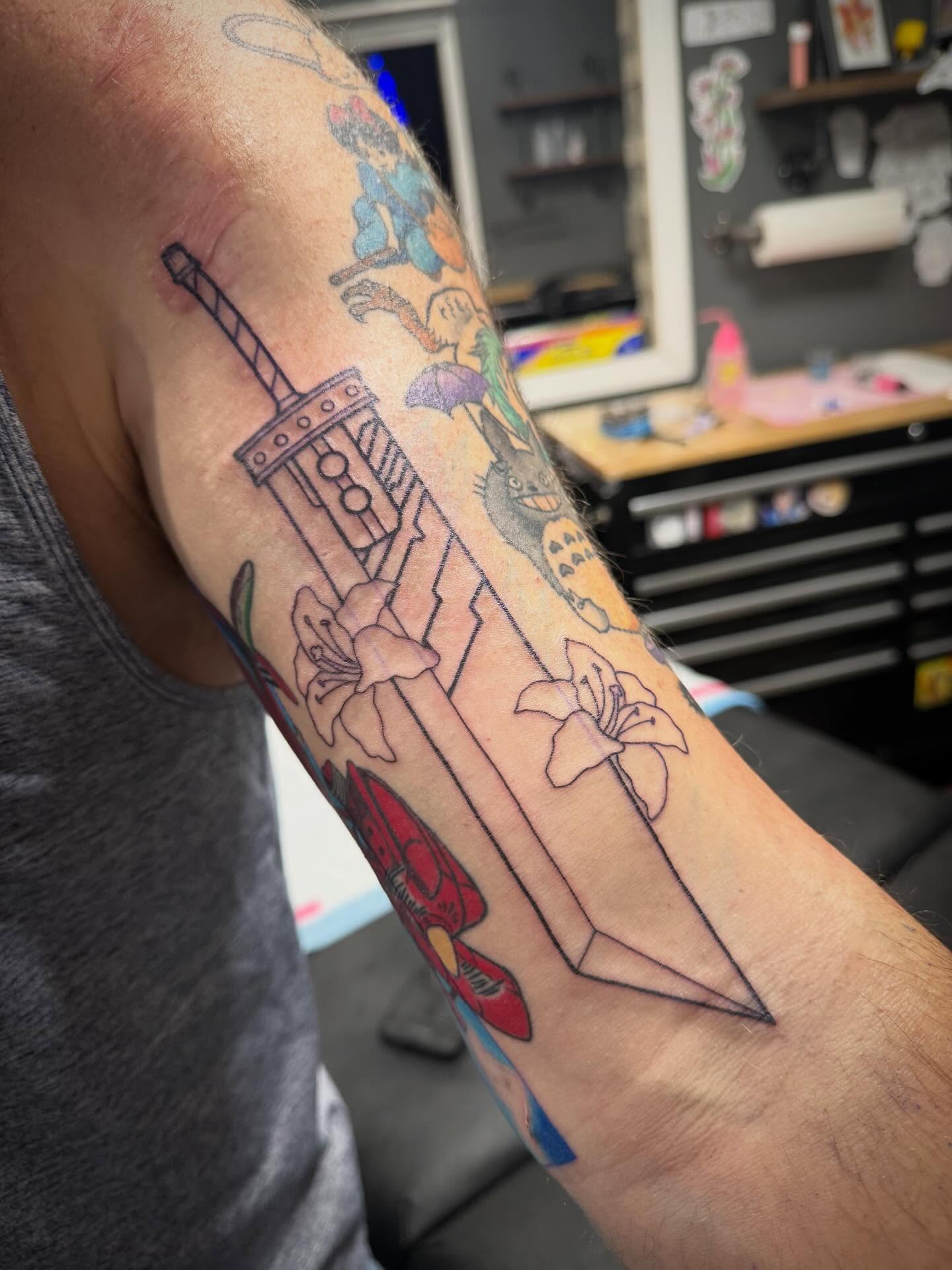 Sword and flowers American traditional tattoo on the forearm by Abby Hofman