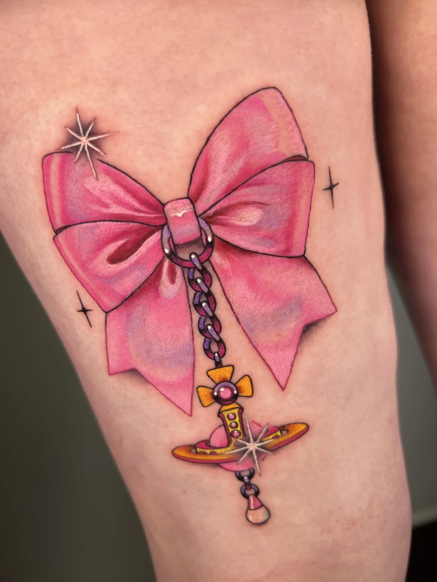Pink bow and chain new school tattoo on the thigh by Chloe Marie