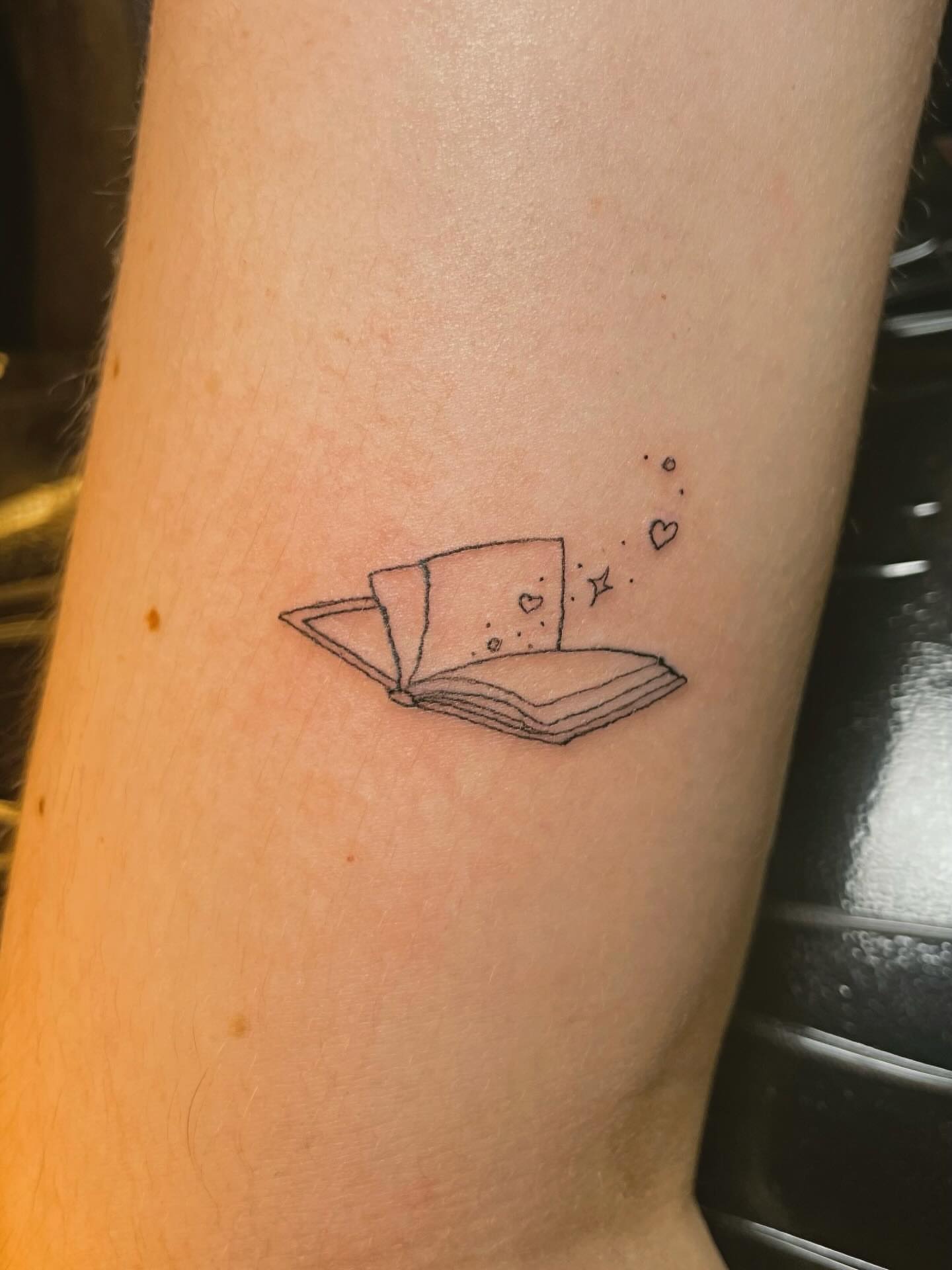 Open book dotwork tattoo on the forearm by 𝚃𝙰𝚃𝚃𝙾𝙾 𝙰𝚁𝚃𝙸𝚂𝚃, Charlotte, North Carolina