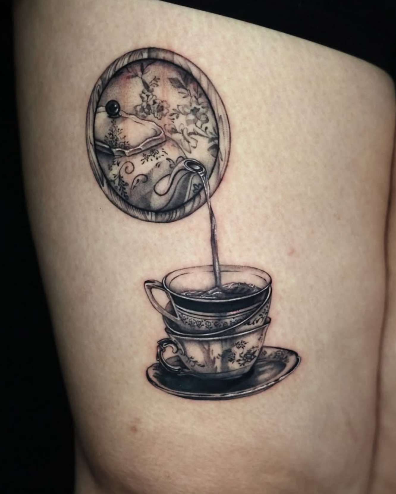 Tea cup and saucer realism tattoo on the thigh by Tiny