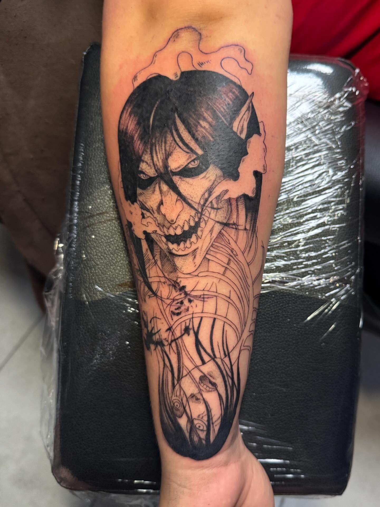 Joker dark realism tattoo on the forearm by Lindsay