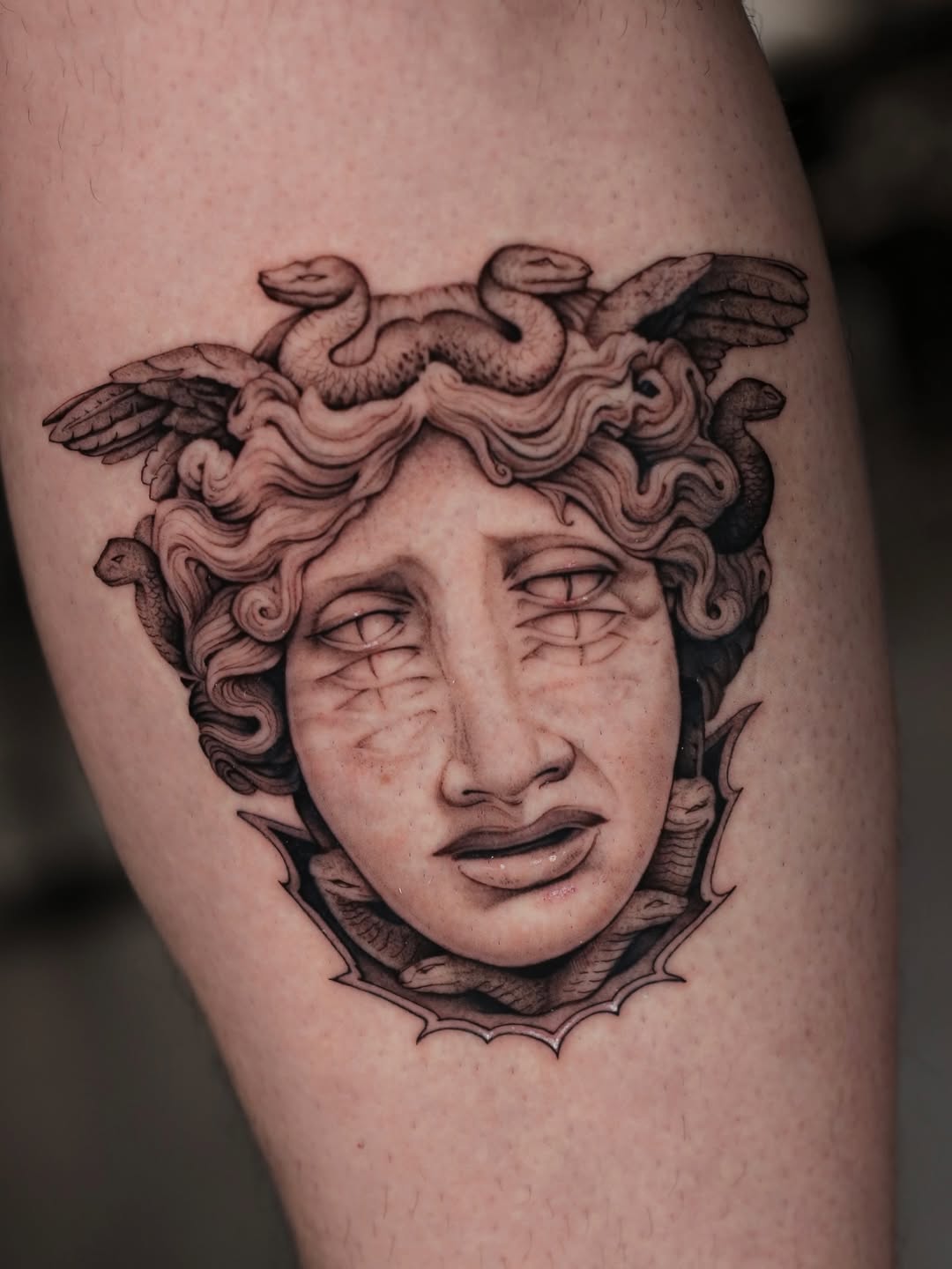 Medusa head with snakes realism tattoo on the thigh by Steve Franciosa