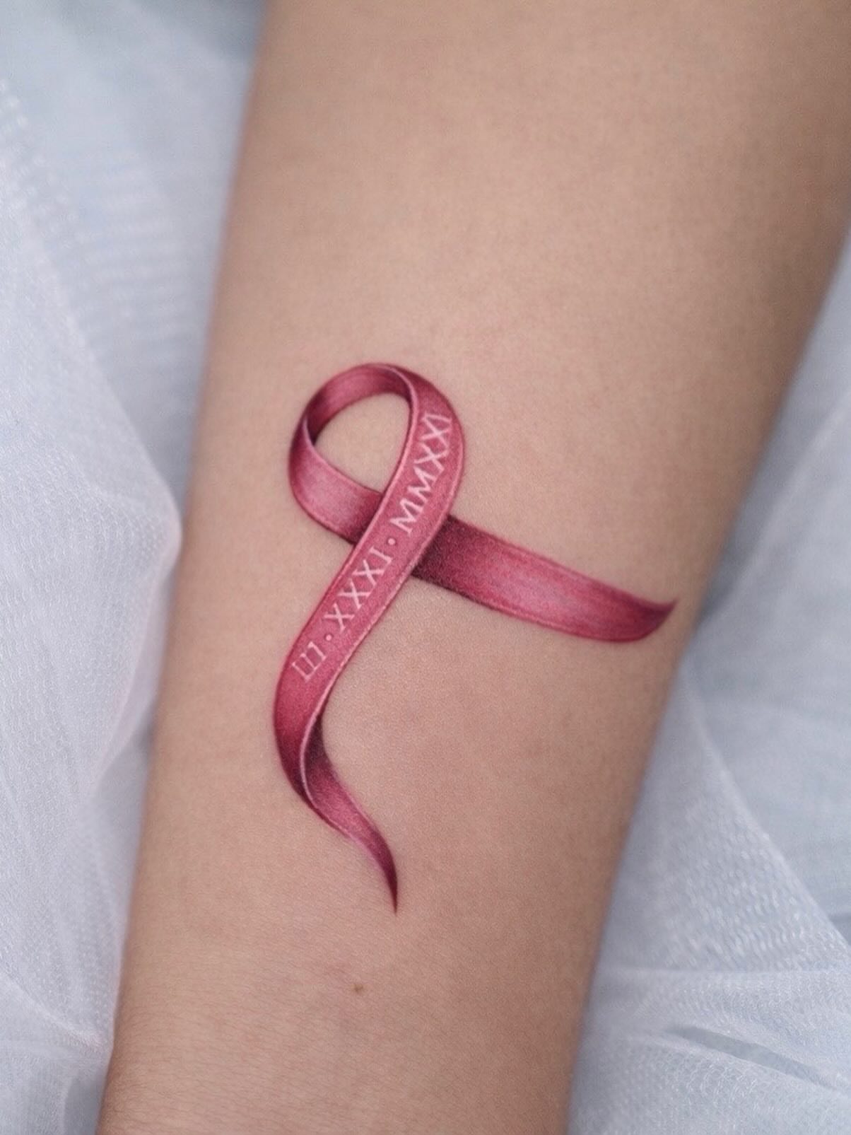 Breast cancer awareness ribbon realism tattoo on the forearm by New Root Ink _Studio