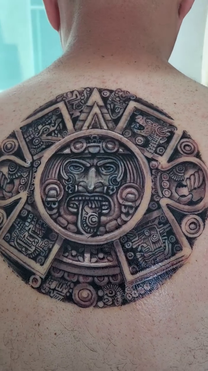 Aztec calendar stone realism tattoo by Aguascali Firme
